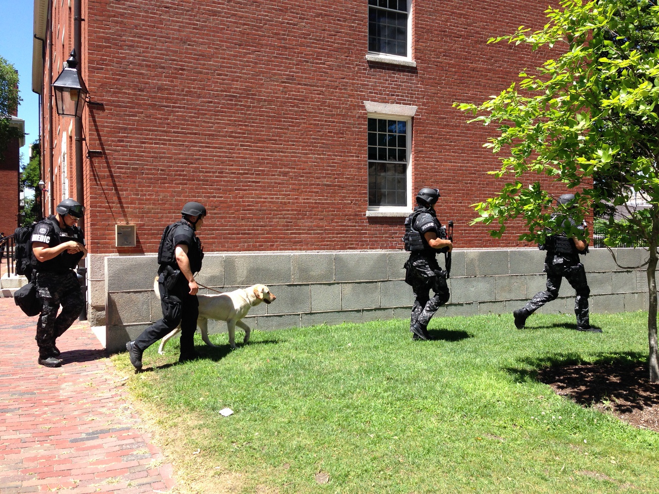 Local authorities leave Holworthy Hall in Harvard Yard after sweeping the building for potential bombs early Saturday afternoon.