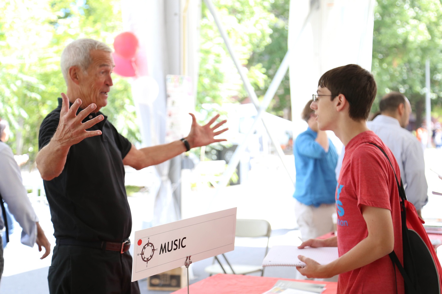 Music professor Thomas F. Kelly speaks with a prospective student at the Academic Fair on Friday afternoon. Kelly explained, "I really love meeting a whole new freshman class...sometimes you just want to say, 'it's all going to be okay.'"