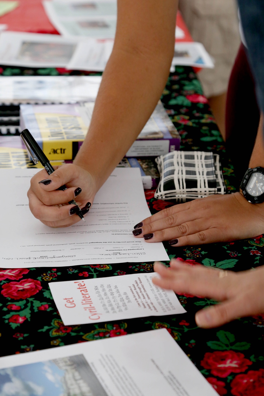 Ellen Jang-Milsen '18 of Georgia fills out a questionnaire for the Department of Slavic Languages and Literatures at the Academic Fair in the Science Center Plaza on Friday. Jang-Milsen, whose high school did not offer Russian, plans to study the language at Harvard.