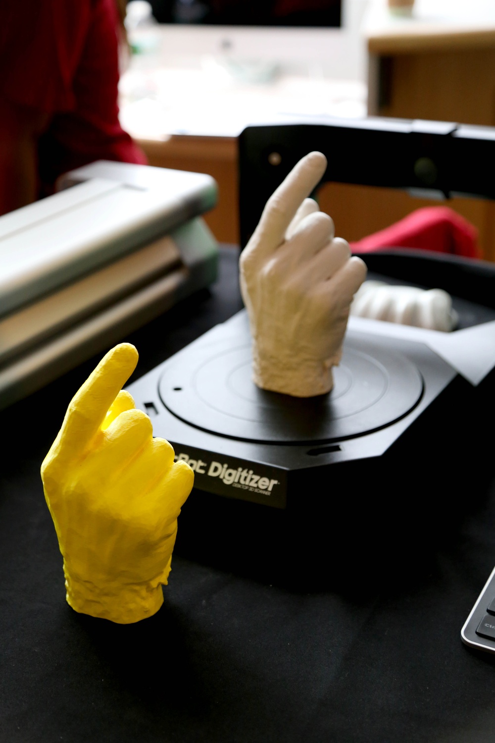 A white plaster cast and its replicate rest near a 3D printing device at the SEAS table at the Academic Fair on Friday.