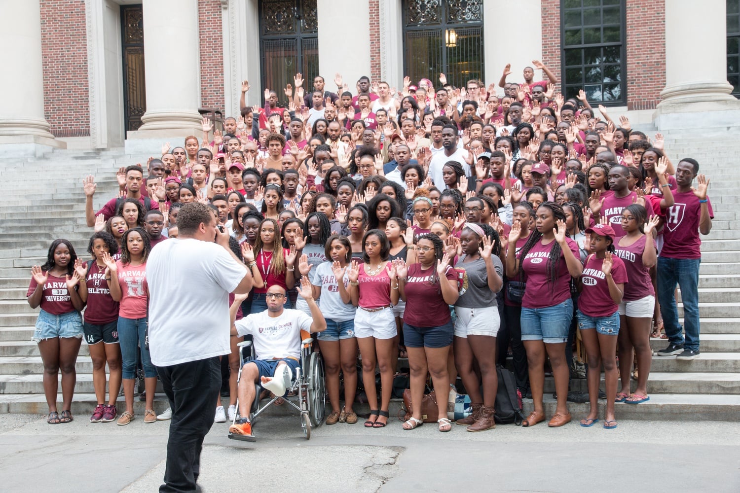 Nearly 200 black Harvard affiliates posed with their hands up for a group photograph on the steps of Widener Library Sunday evening in solidarity with Michael Brown, an unarmed black teenager killed three weeks ago in Ferguson, Missouri.