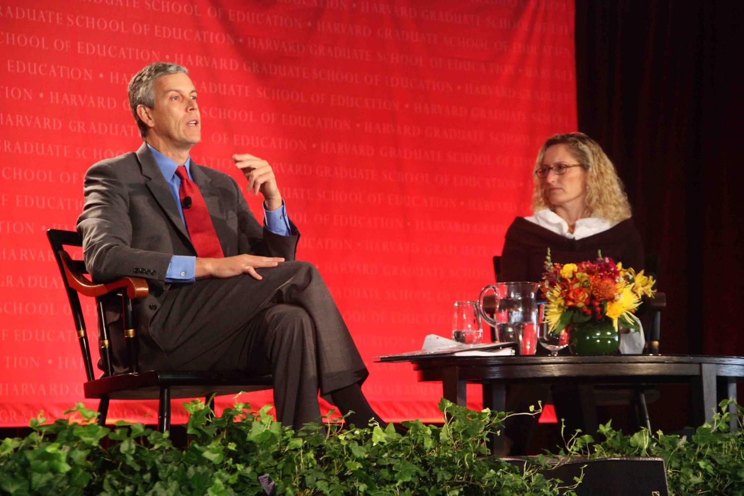 U.S. Secretary of Education Arne S. Duncan '86 speaks with professor Monica Higgins about the Common Core testing standards during the Graduate School of Education's capital campaign launch Friday.