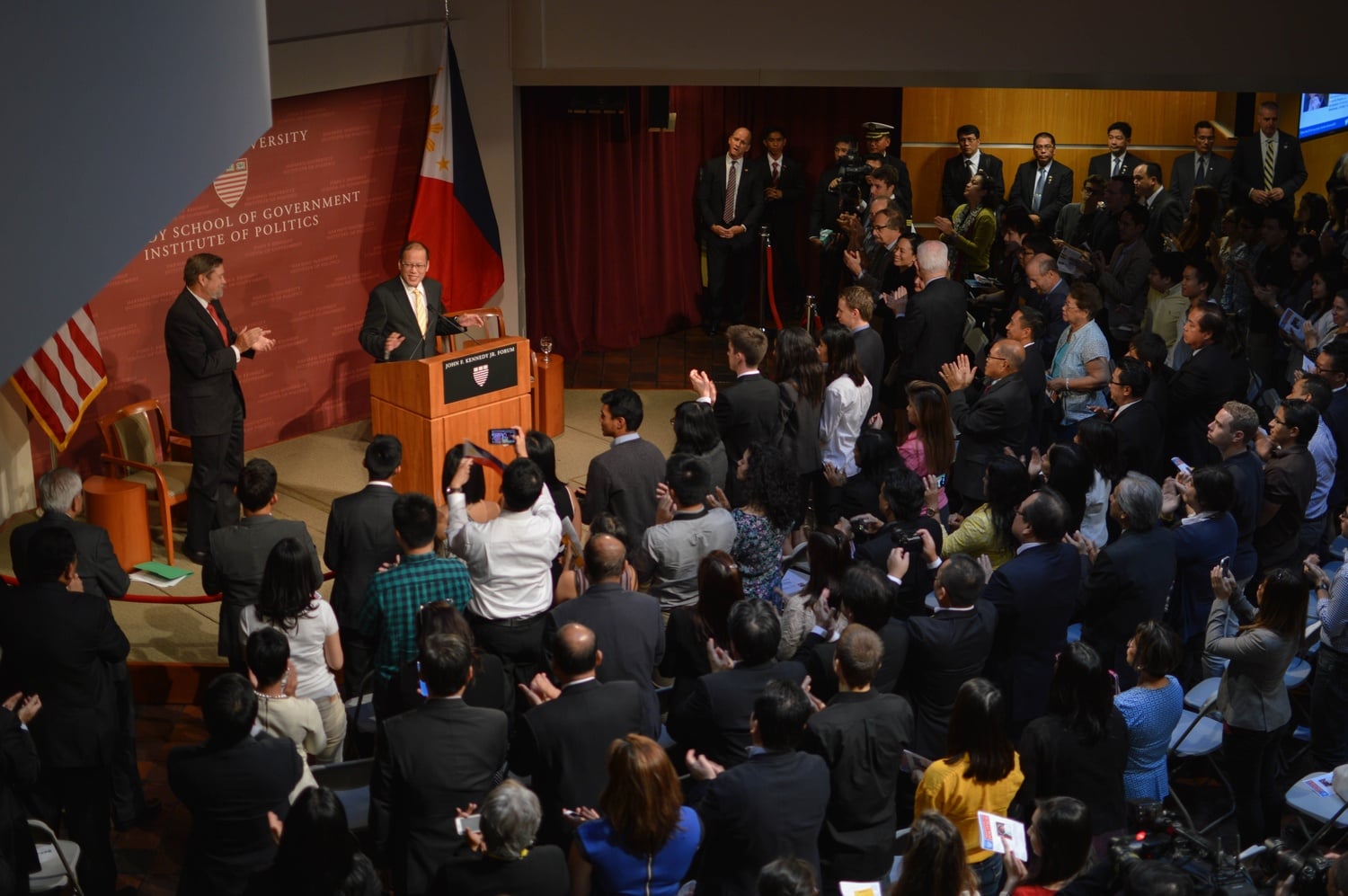 The Institute of Politics crowd rises as Benigno Aquino III, incumbent president of the Philippines, takes the stage. 