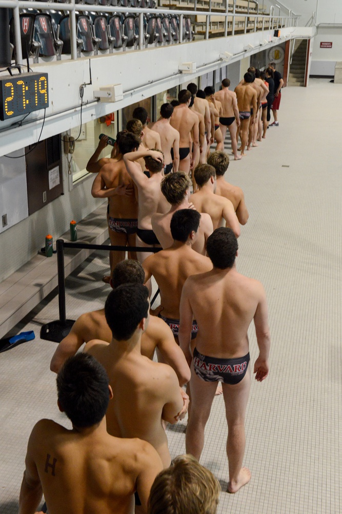 The Harvard Men's Swimming and Diving team gathers in the dark at Blodgett pool at midnight for their first official practice of the season. This tradition marked the beginning of the Ivy League swimming season on Wednesday. 