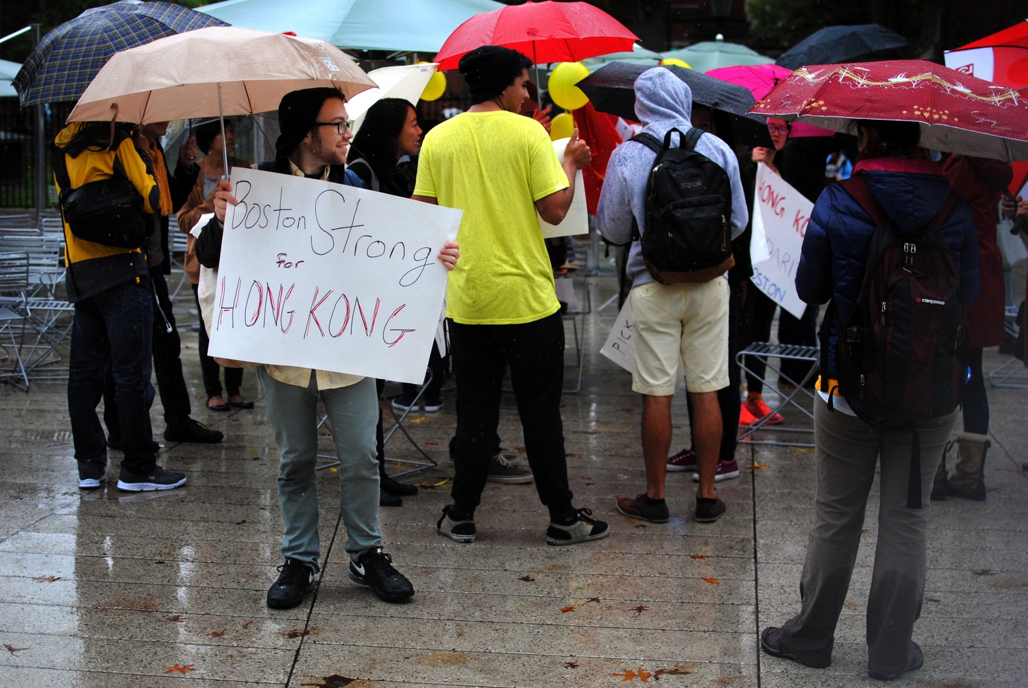 Jared Fries, a Harvard Graduate School of Education student, advocates for peace in Hong Kong on Wednesday. Fries was one of many students who gathered in the Science Center Plaza to show their support for the ongoing freedom movement. 
