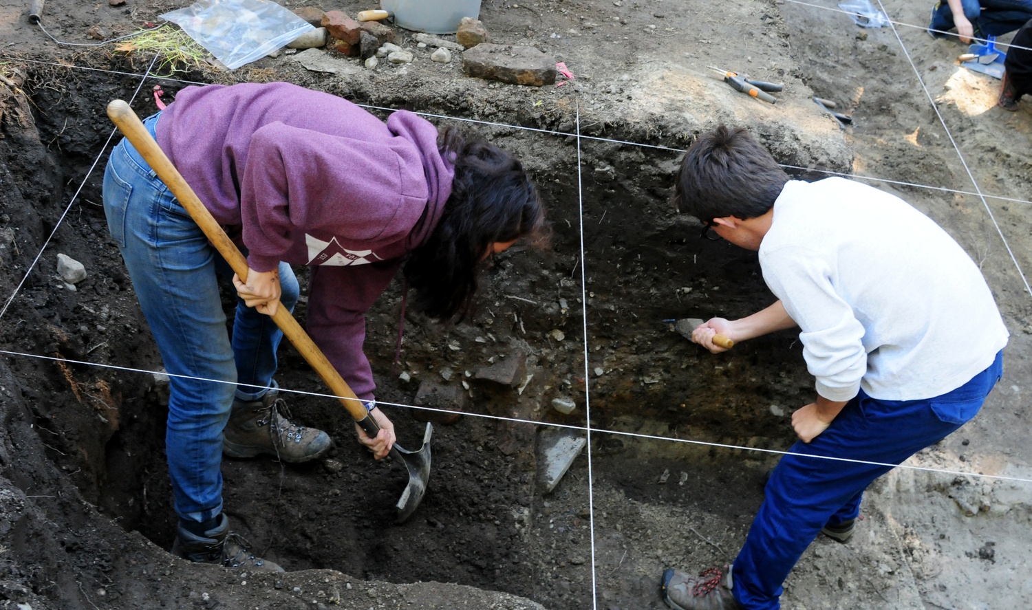Cristina S. Parajon '18 and Santiago Pardo '16 dig for buried artifacts in Harvard Yard. The Archaeology Fair was held by the Peabody Museum and the Semitic Museum on Oct. 5, 2014.