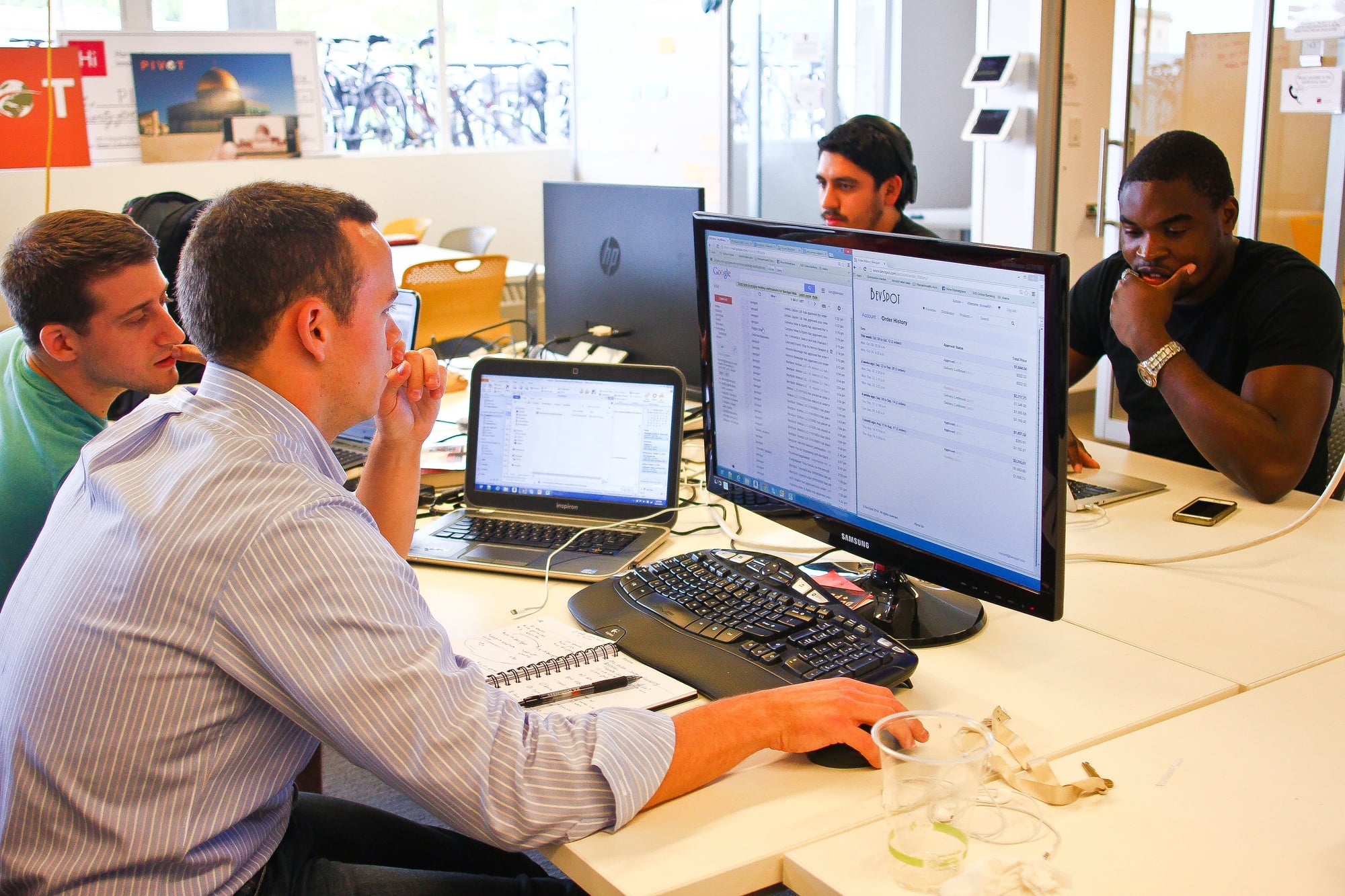 Members of the Bevspot team, based in the Harvard Innovation Lab, work on their project at the space on Tuesday afternoon.