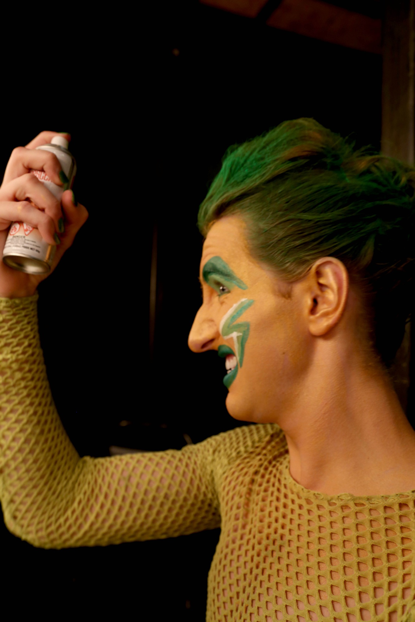 Mauriello sprays his hair as part of his pre-show routine.
