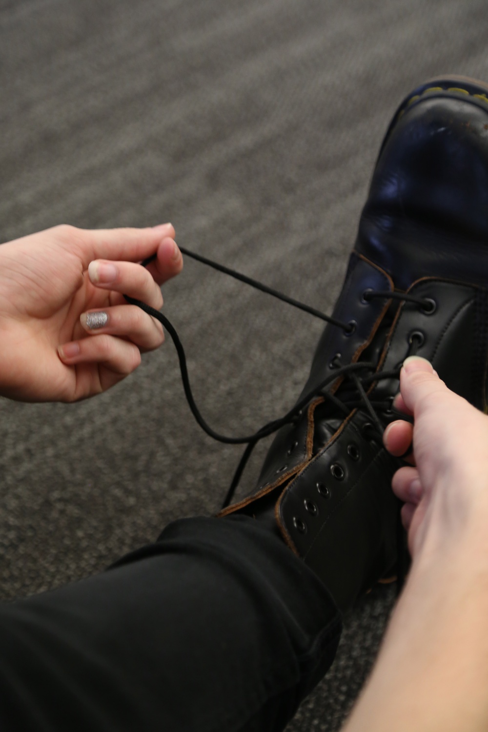 Mauriello ties his combat boots during rehearsal for "Little Murders."