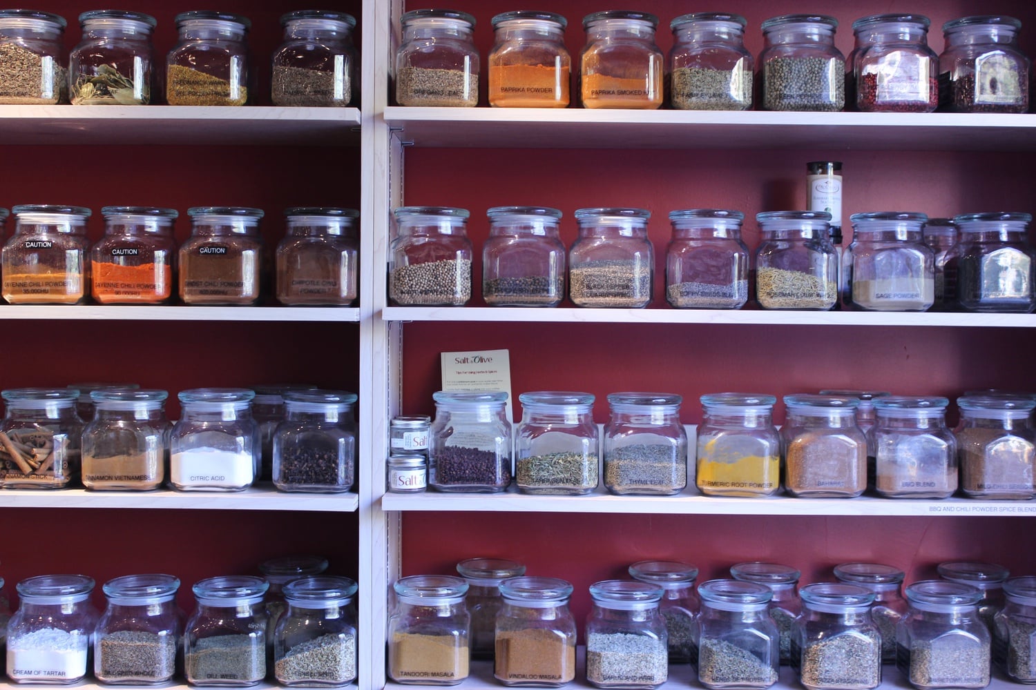 Glass jars of tea and other spices line one wall of Salt & Olive. In addition to supplying the community with a variety of olive oil and other dips, the store seeks to educate customers on the science of herbs and spices.
