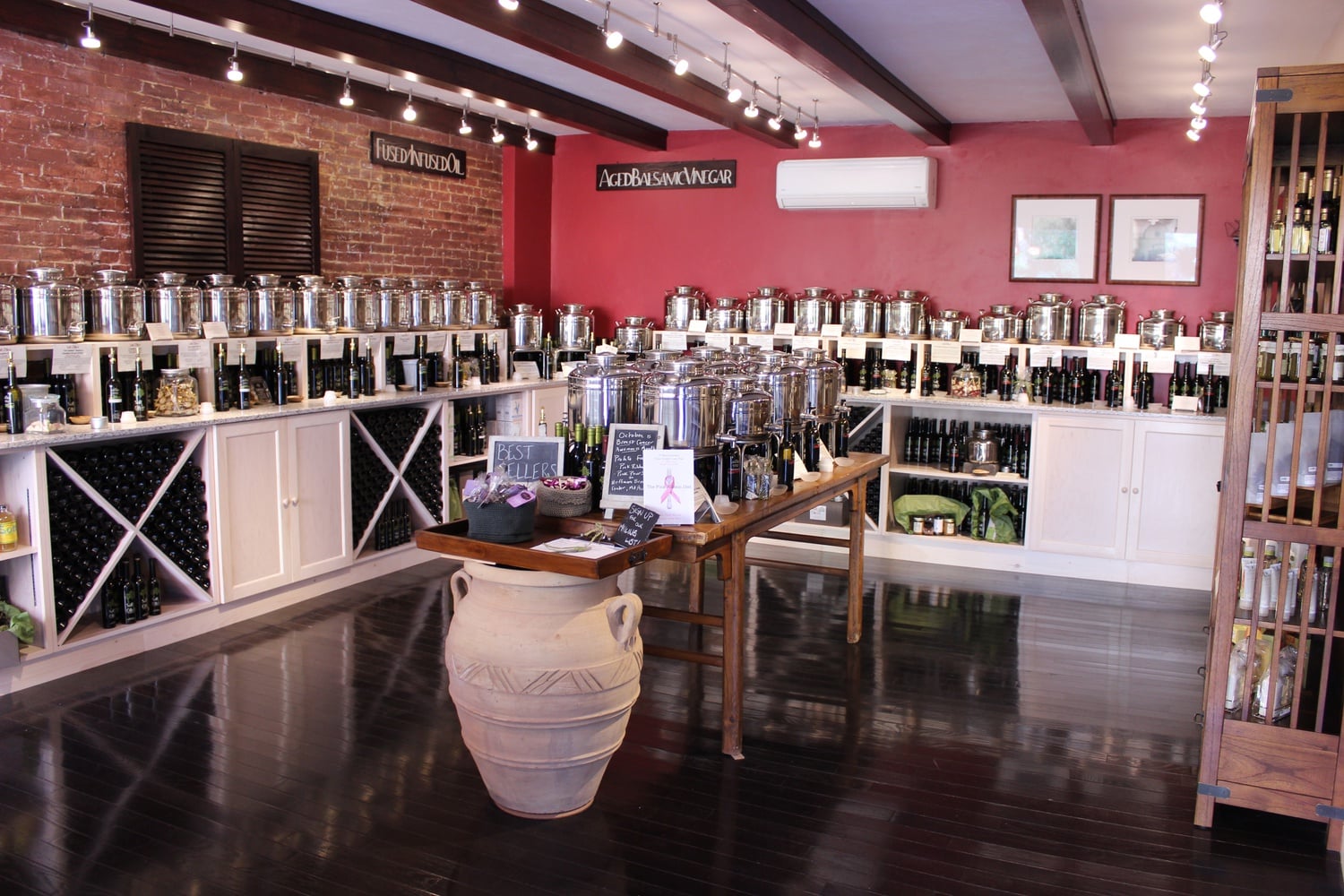 Containers filled with oil and vinegar sit behind a row of samples at Salt & Olive. Bread for dipping and water are offered free of charge to customers.