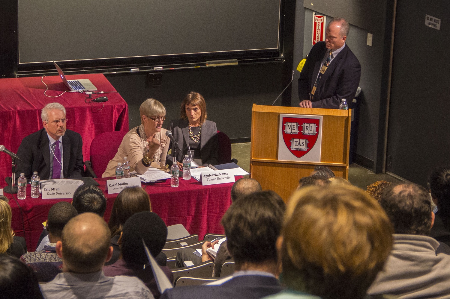 Dean Michael D. Smith, far right, moderates a symposium on the intersection between public service and academics. 