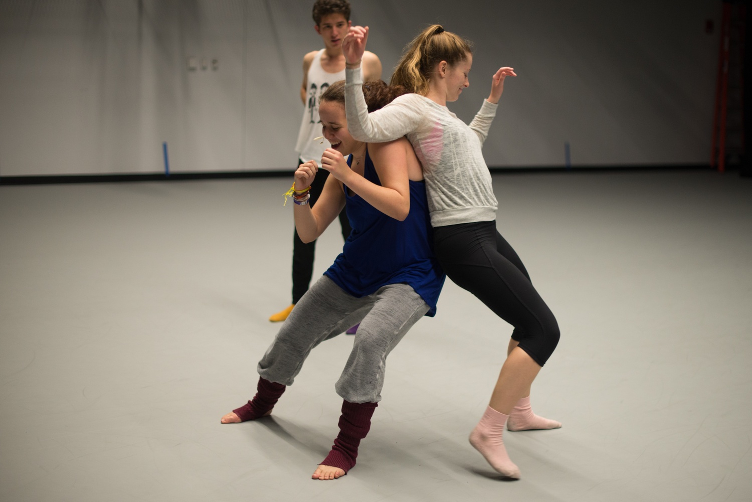 Sofie Rose Seymour '16 demonstrates a warmup designed to strengthen the bond of dancing partners with Anna Riley-Shepard '17 to Michael Sivitz-Gellman '17 during rehearsal for "Being Fine."