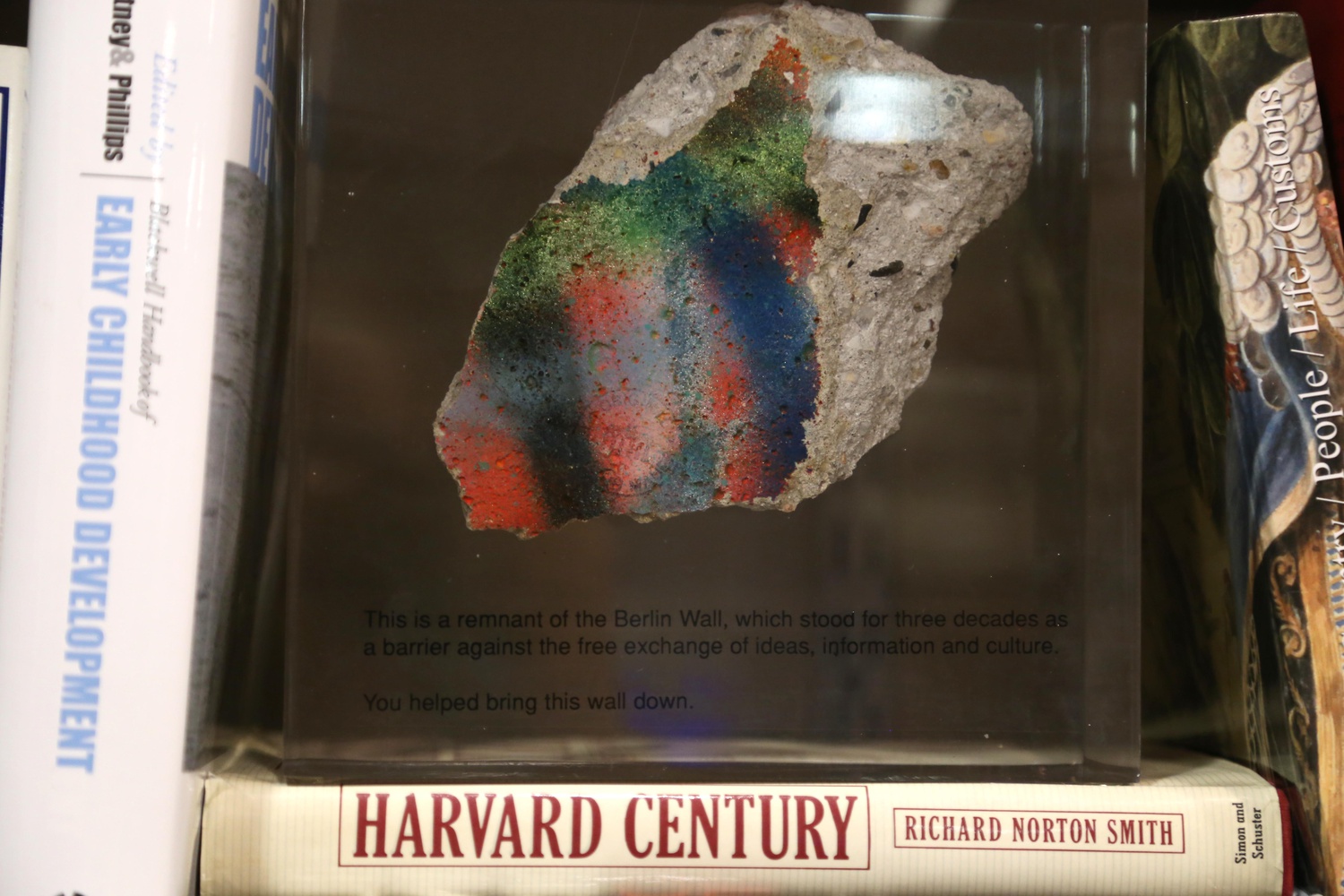 A piece of the Berlin Wall rests upon a book about Harvard's history in Summers' office.