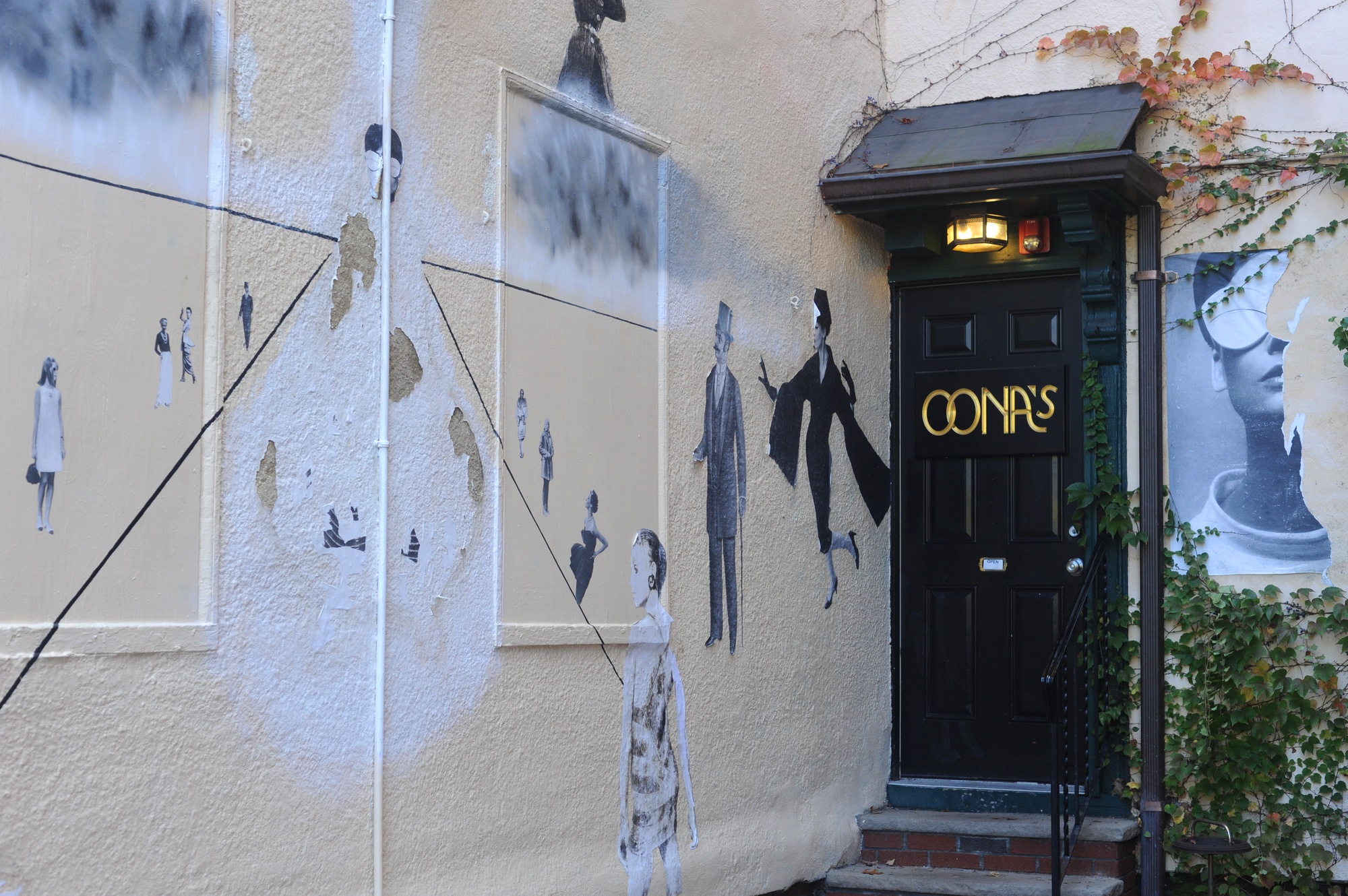 Artwork adorns the walls surrounding the entrance to Oona's Experienced Clothing in Harvard Square.