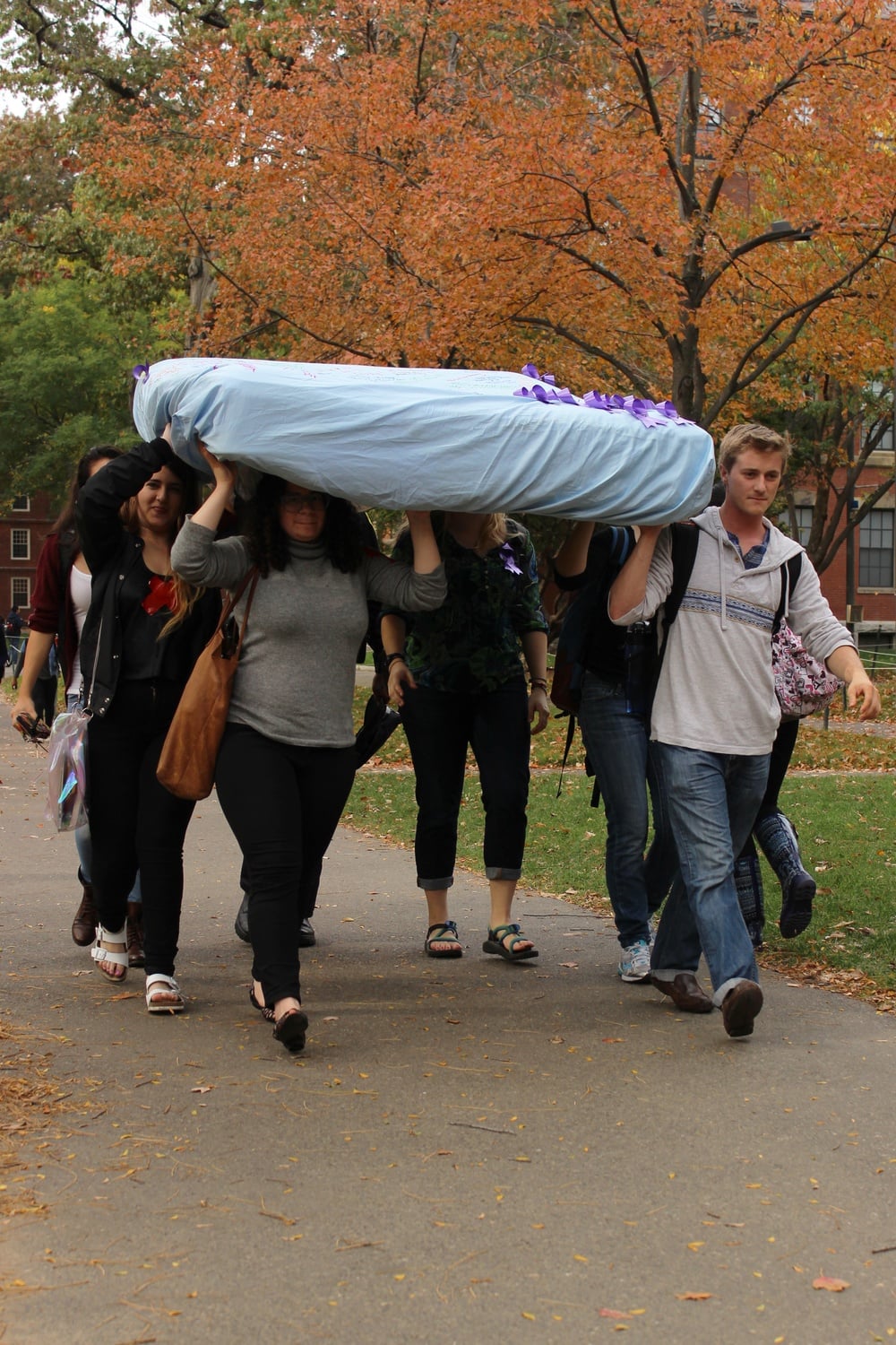 Supporters of the 'Carry That Weight' movement carry a mattress to advocate for victims of sexual and domestic violence throughout Wednesday.