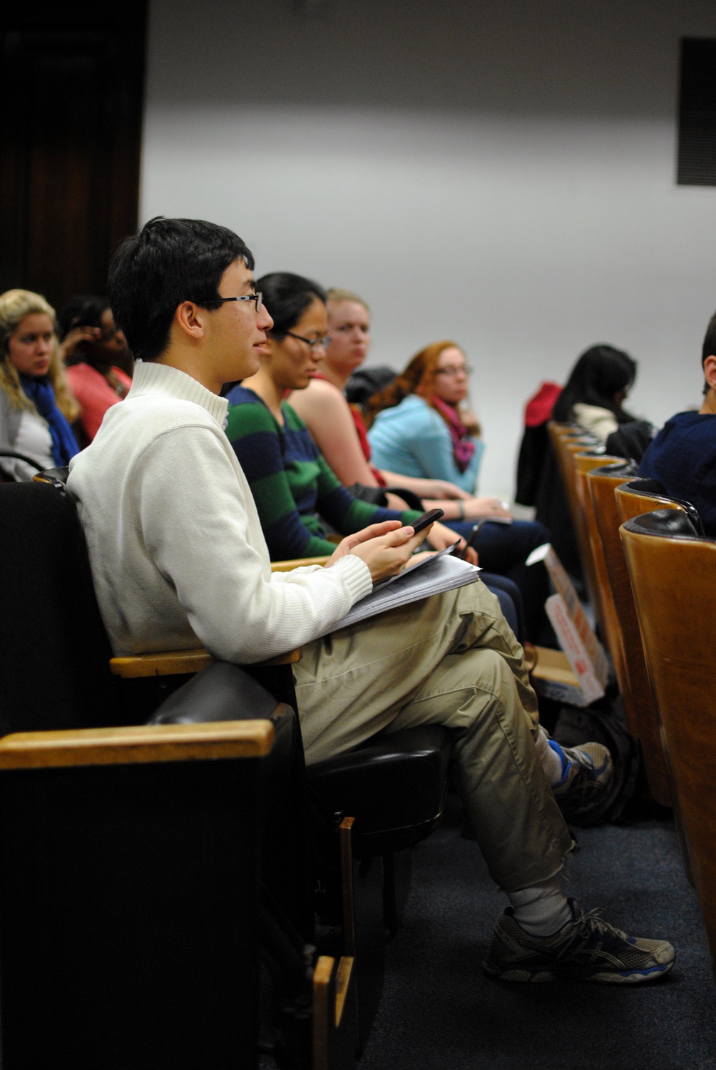 UC Vice President, Sietse K. Goffard '15 asks HUHS panelists an anonymous question during a town hall meeting on Wednesday evening in Emerson Hall. Attendees of the meeting were encouraged to ask questions about changes to HUHS, or text Goffard their inquires if they wished to remain anonymous. 