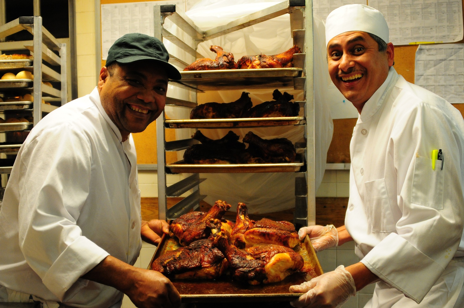 Kirkland Chefs Franklin Espinal and Luis Olmebo display their prepared turkeys for Thursday night's Thanksgiving dinner special.  
