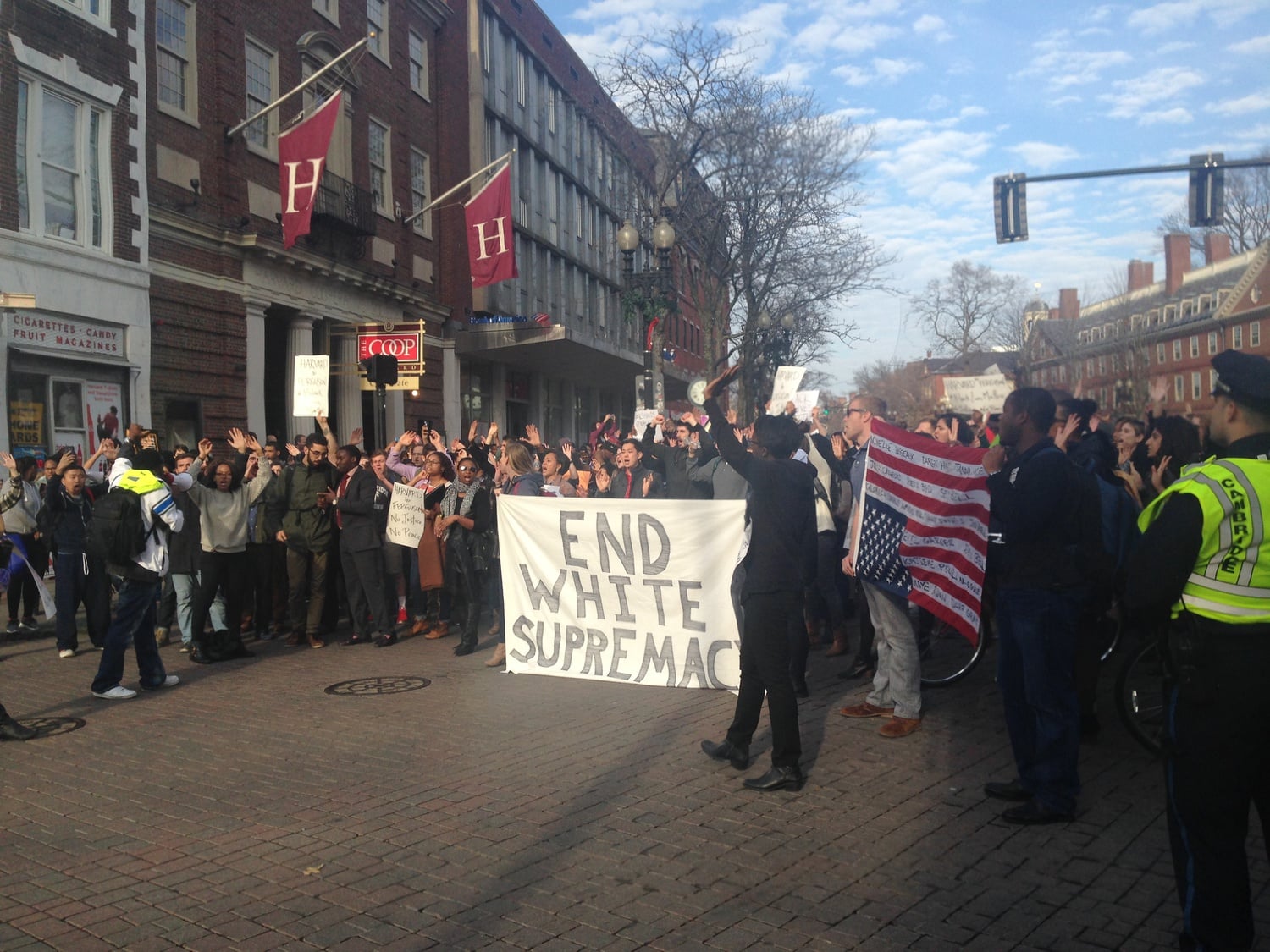Protesters rally on a blockaded Mass. Ave. in front of the Harvard Coop Monday afternoon.