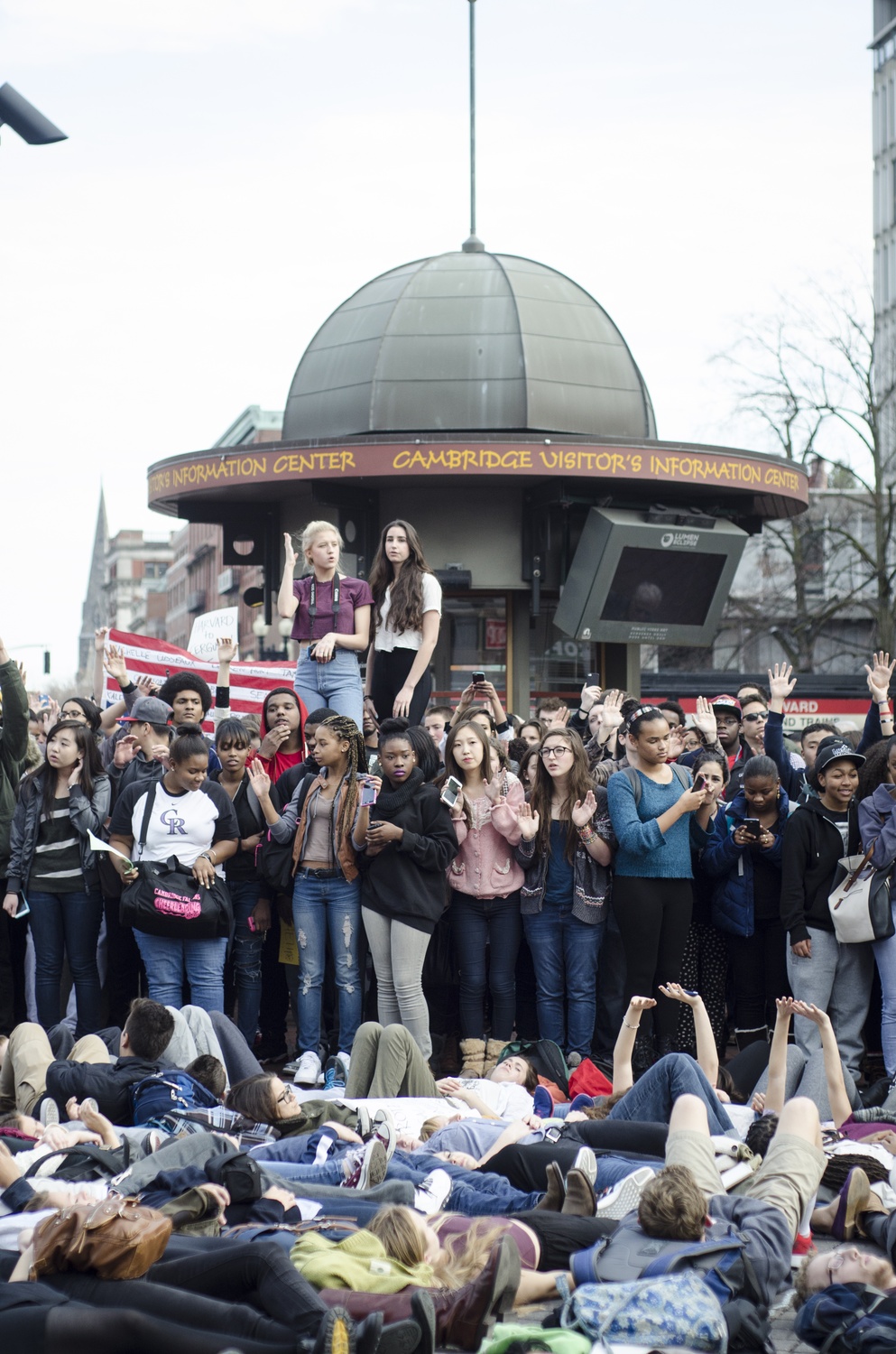 Dozens of students from Cambridge Ringe and Latin School and Harvard University lay in the street to protest the shooting of Michael Brown, an unarmed black teenager, by Ferguson policeman Darren Wilson. The walk-out began at 1:01 pm, the time at which Brown was shot, on Monday afternoon.
