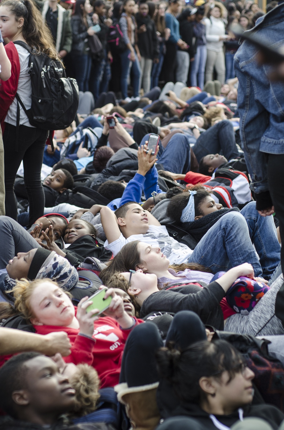 Dozens of students from Cambridge Ringe and Latin School and Harvard University lay in the street to protest the shooting of Michael Brown, an unarmed black teenager, by Ferguson Policeman Darren Wilson. The walk-out began at 1:01 pm, the time at which Brown was shot, on Monday afternoon.