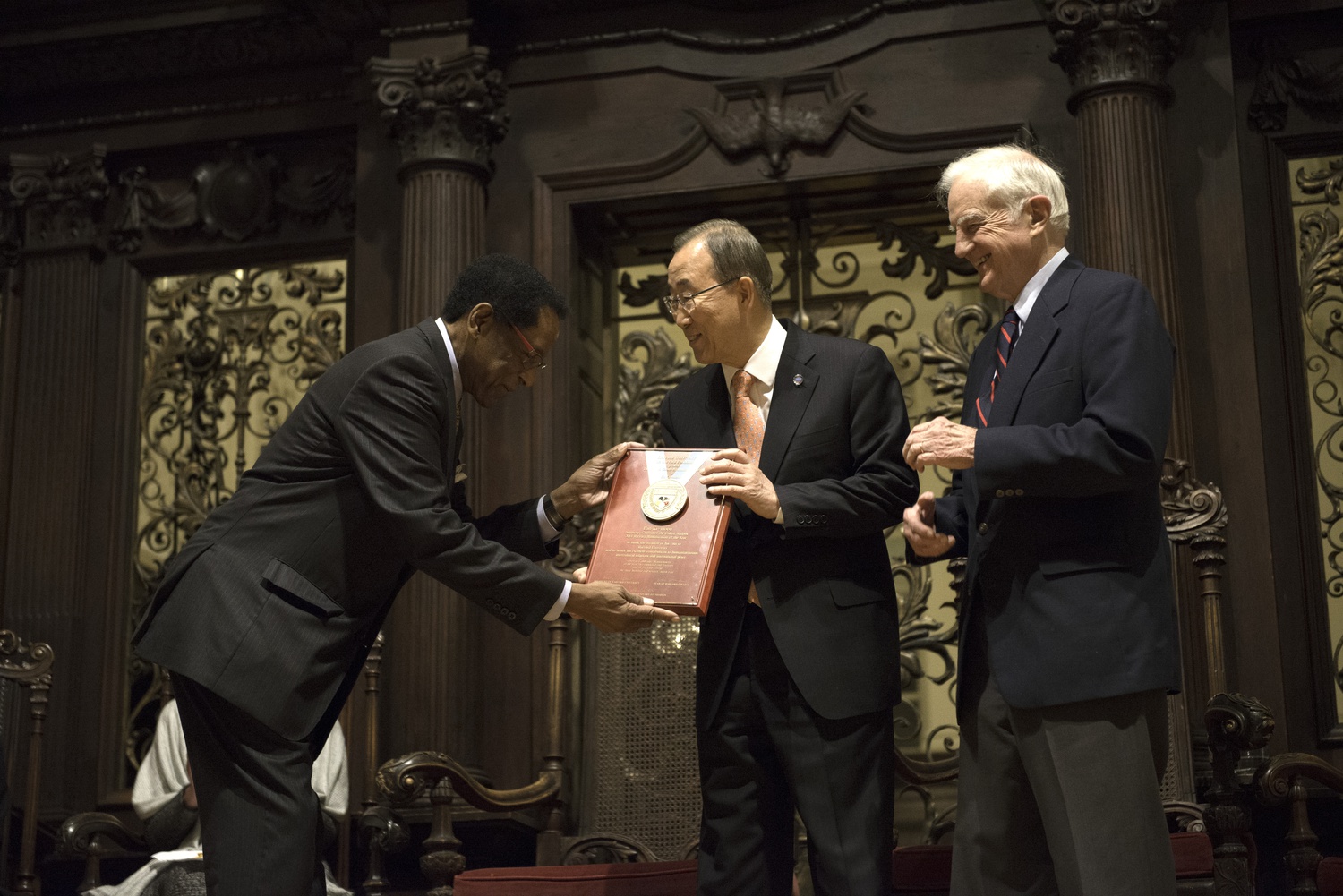 Ban Ki Moon accepts the Harvard Foundation Peter J. Gomes Humanitarian Award as the 2014 Humanitarian of the Year on Tuesday in Memorial Church. Dr. S. Allen Counter Jr., the Director of the Harvard Foundation, and Derek C. Bok presented the award.