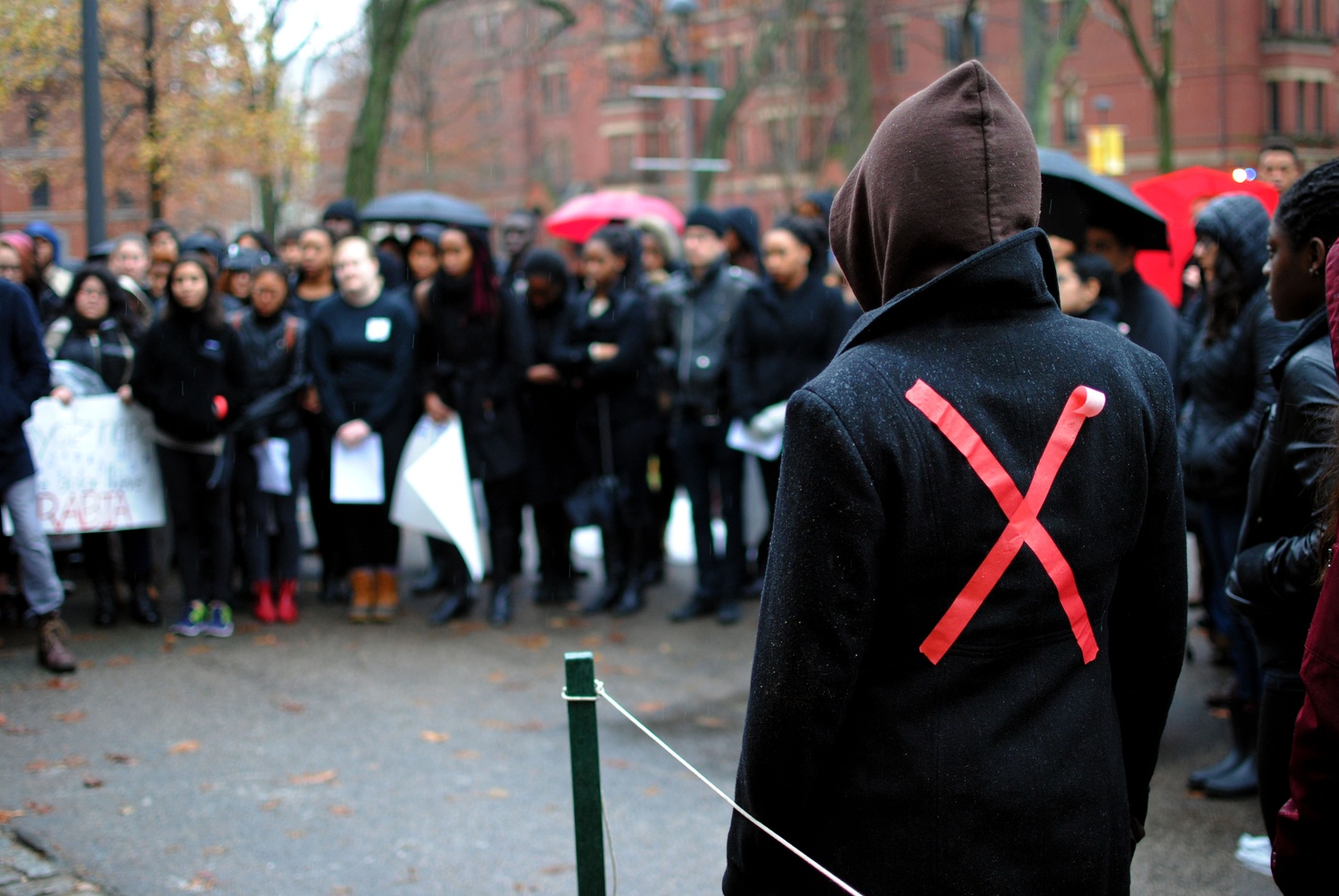 Members of the Harvard community donned red "X"s to symbolize black people being treated as targets during protest Wednesday morning outside University Hall, spurred by a St. Louis County grand jury decision not to indict police officer Darren Wilson for killing a black, unarmed teenager, Michael Brown. 