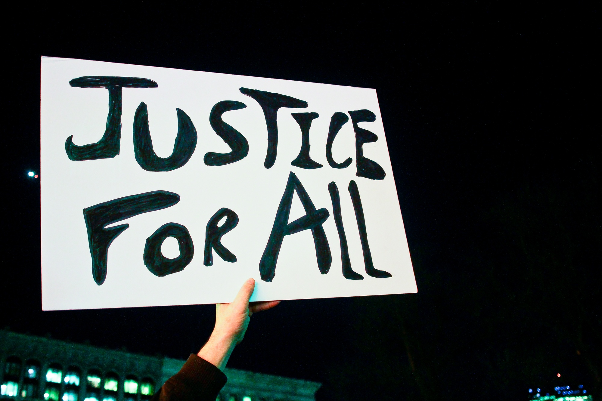 A protester brandishes a sign at the Eric Garner protest Thursday night.