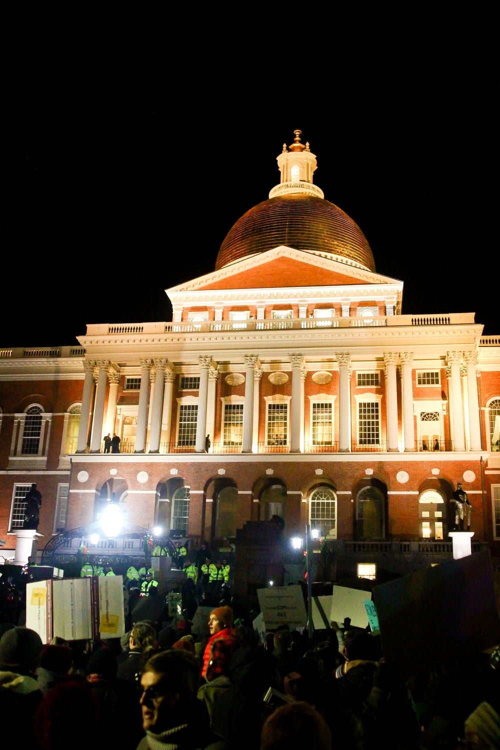 Protesters gather at the front of the Massachusetts State House.