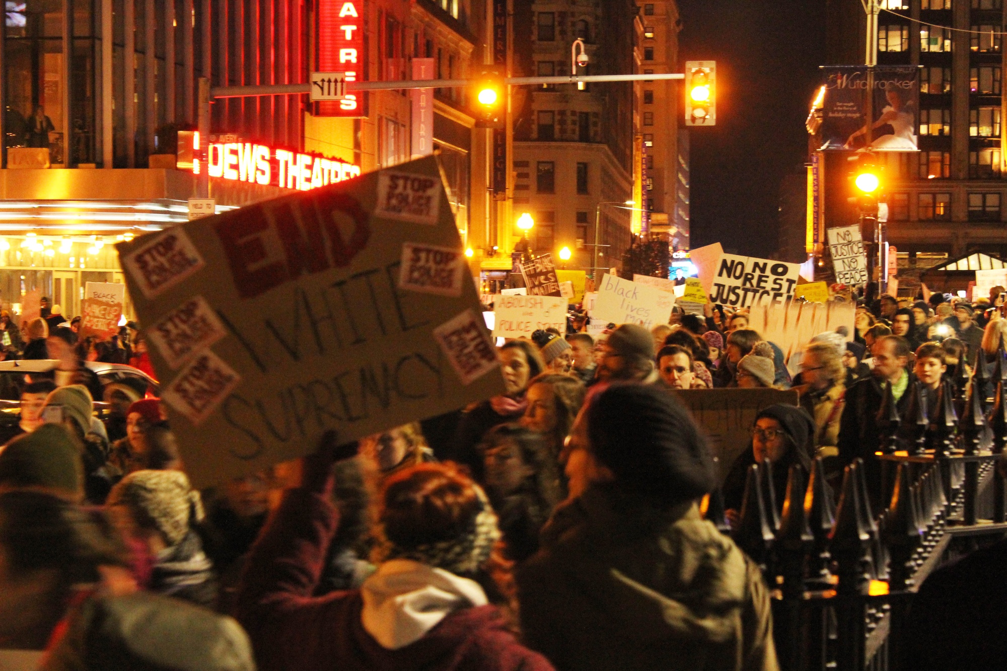 Protestors gather outside of the AMC Boston Common Theater.