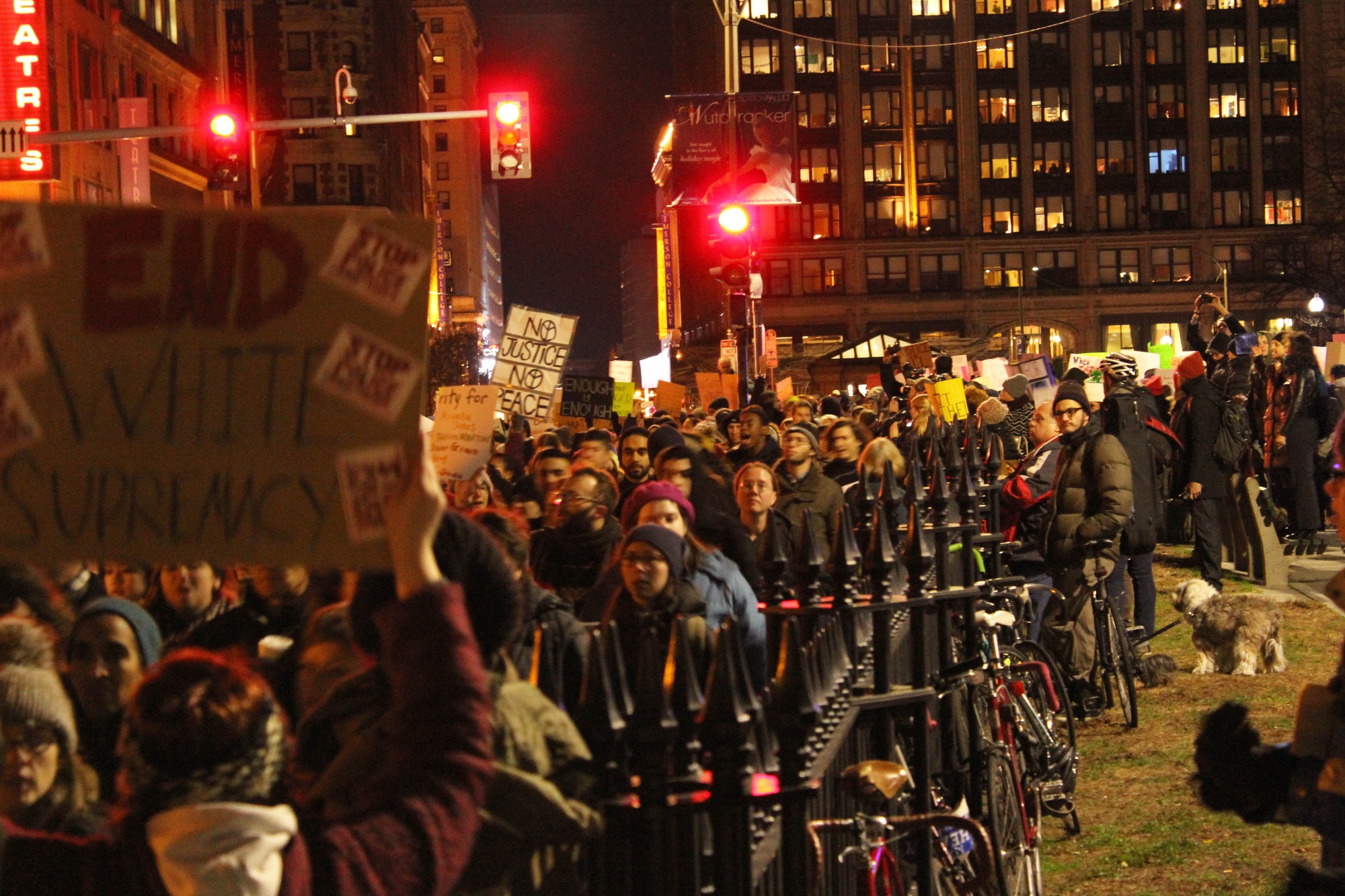 Protestors march on Tremont Street outside of the AMC Boston Common movie theater.