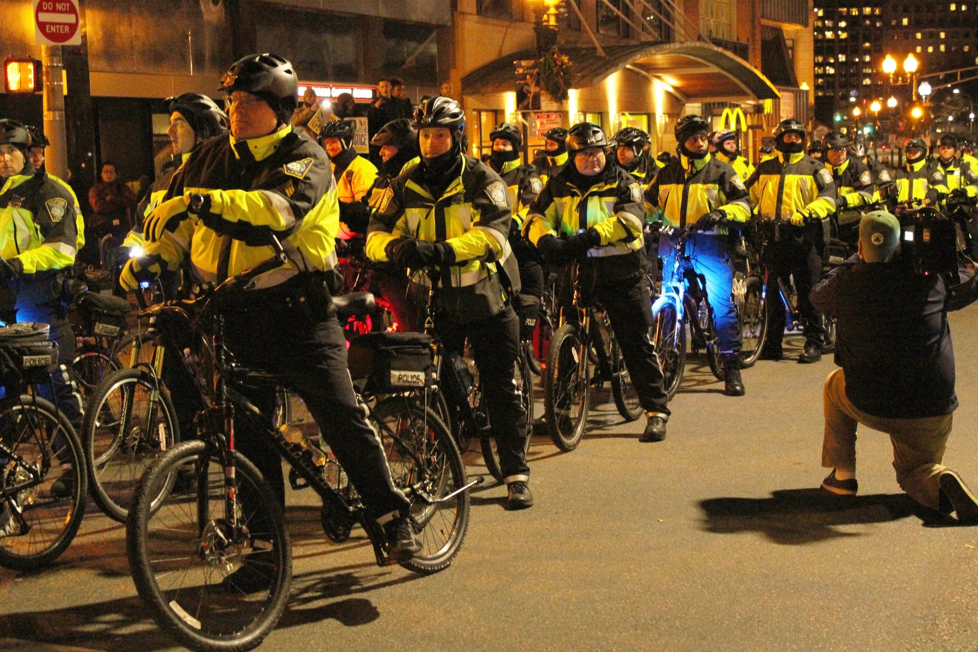 Boston police officers line the street on their bicycles in preparation.