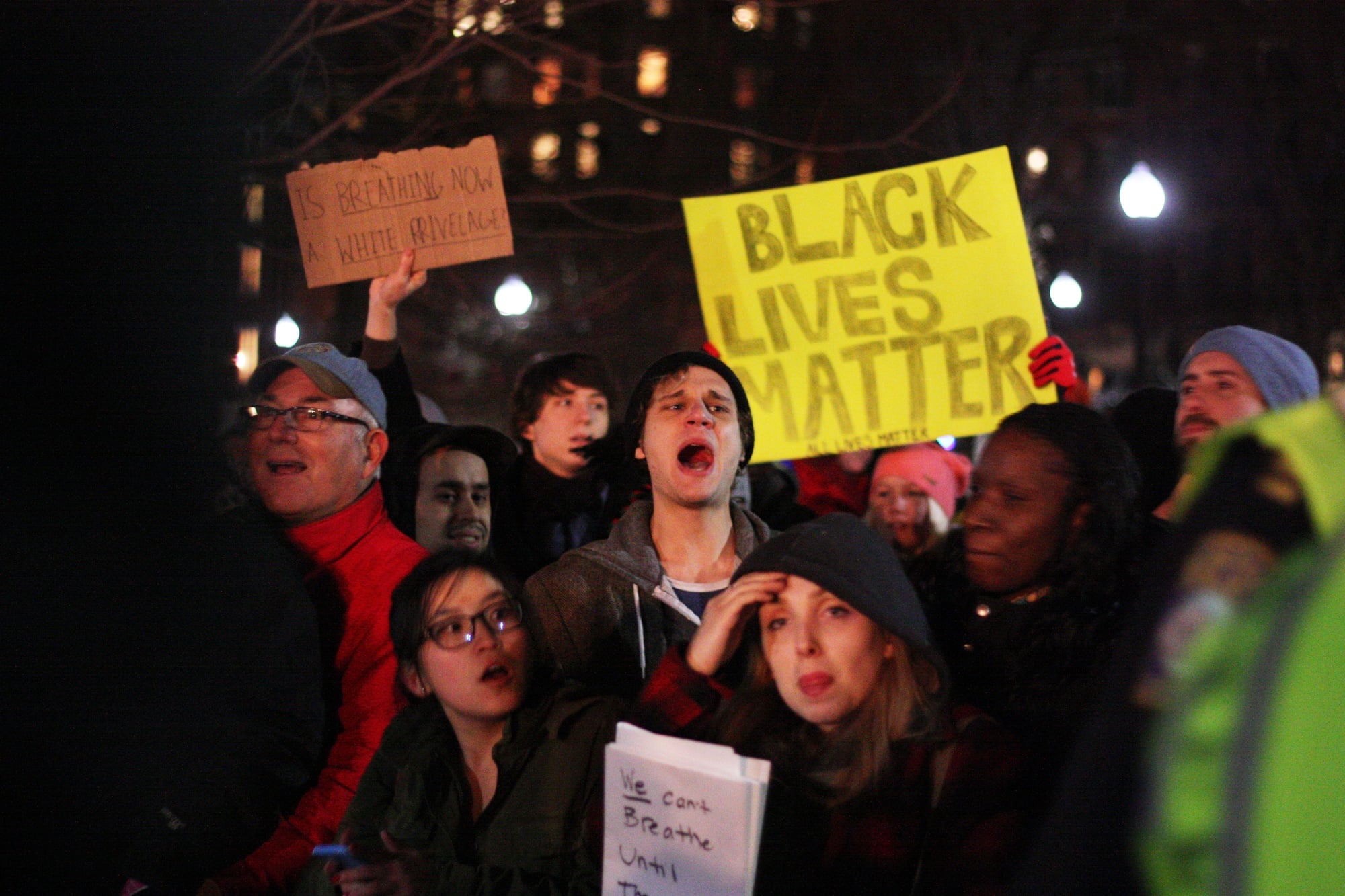 Protestors push against the guardrails as they rally. 