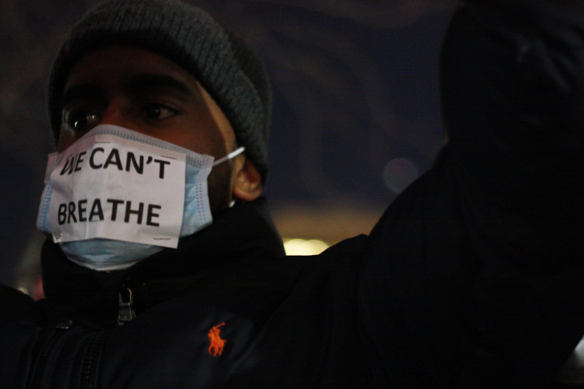 A demonstrator wears a surgical mask over his face to protest the Eric Garner case.