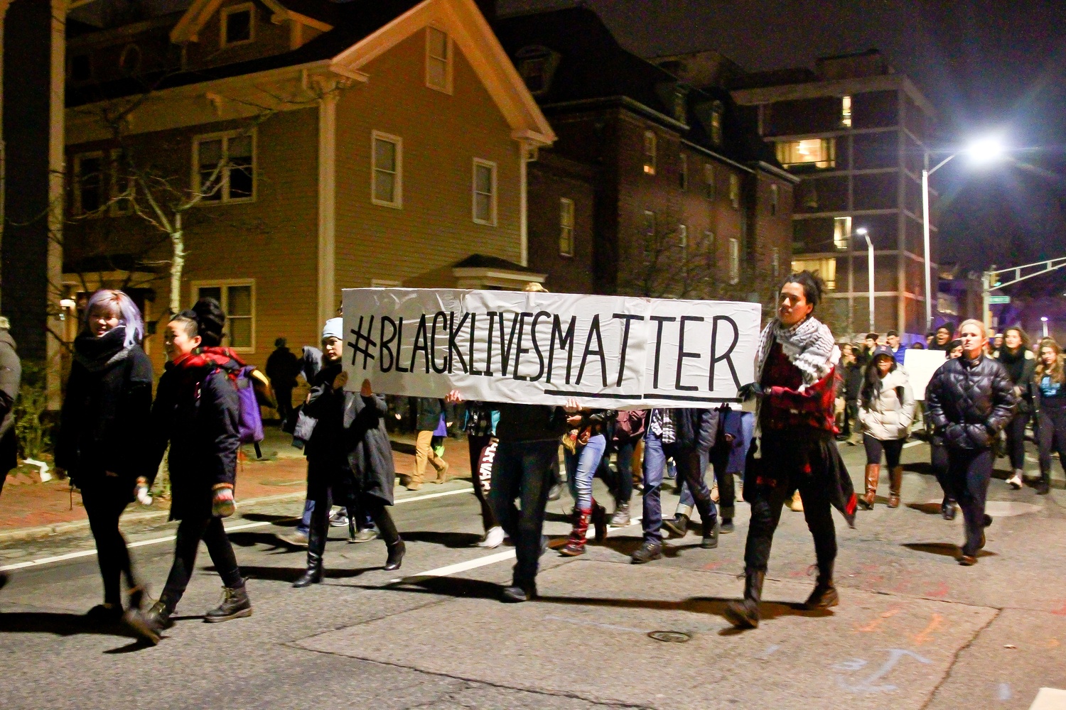 Protestors march down Mt. Auburn street towards Central Square.