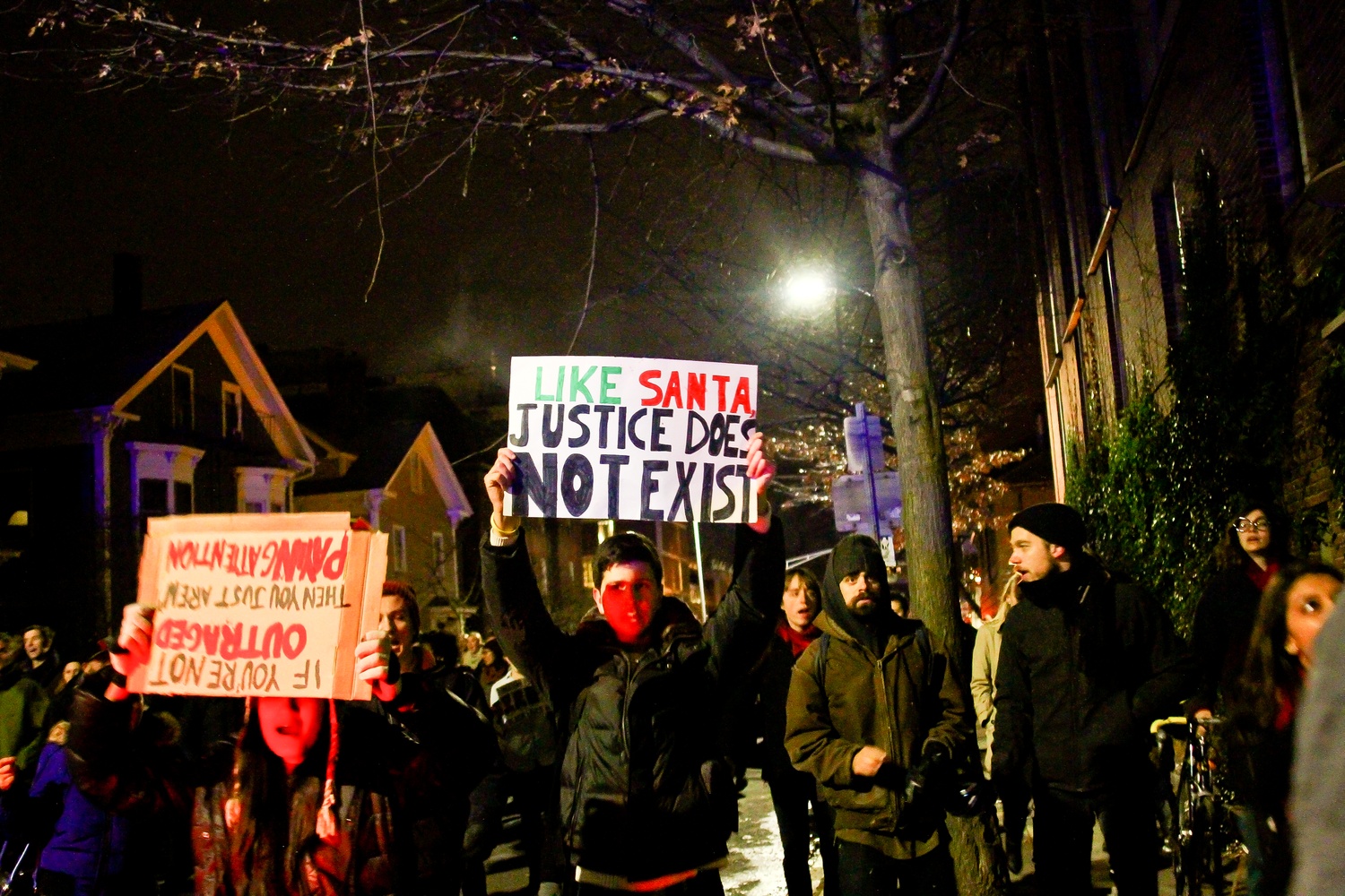 Protestors march down Mt. Auburn street towards Central Square.
