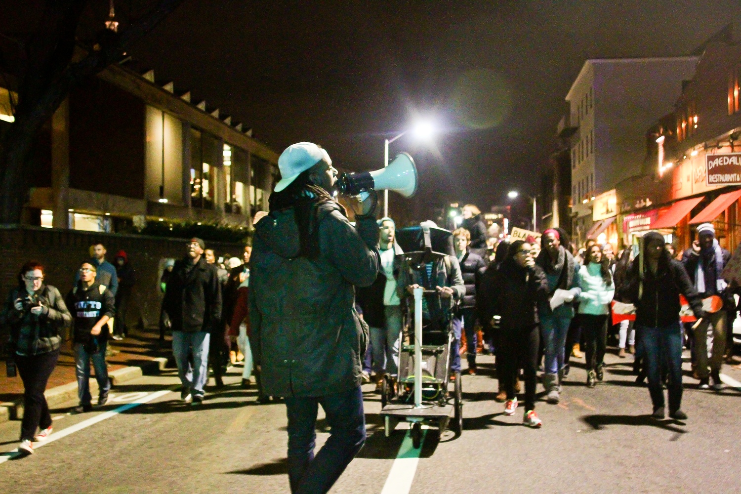 Protestors march down Mt. Auburn street towards Central Square.