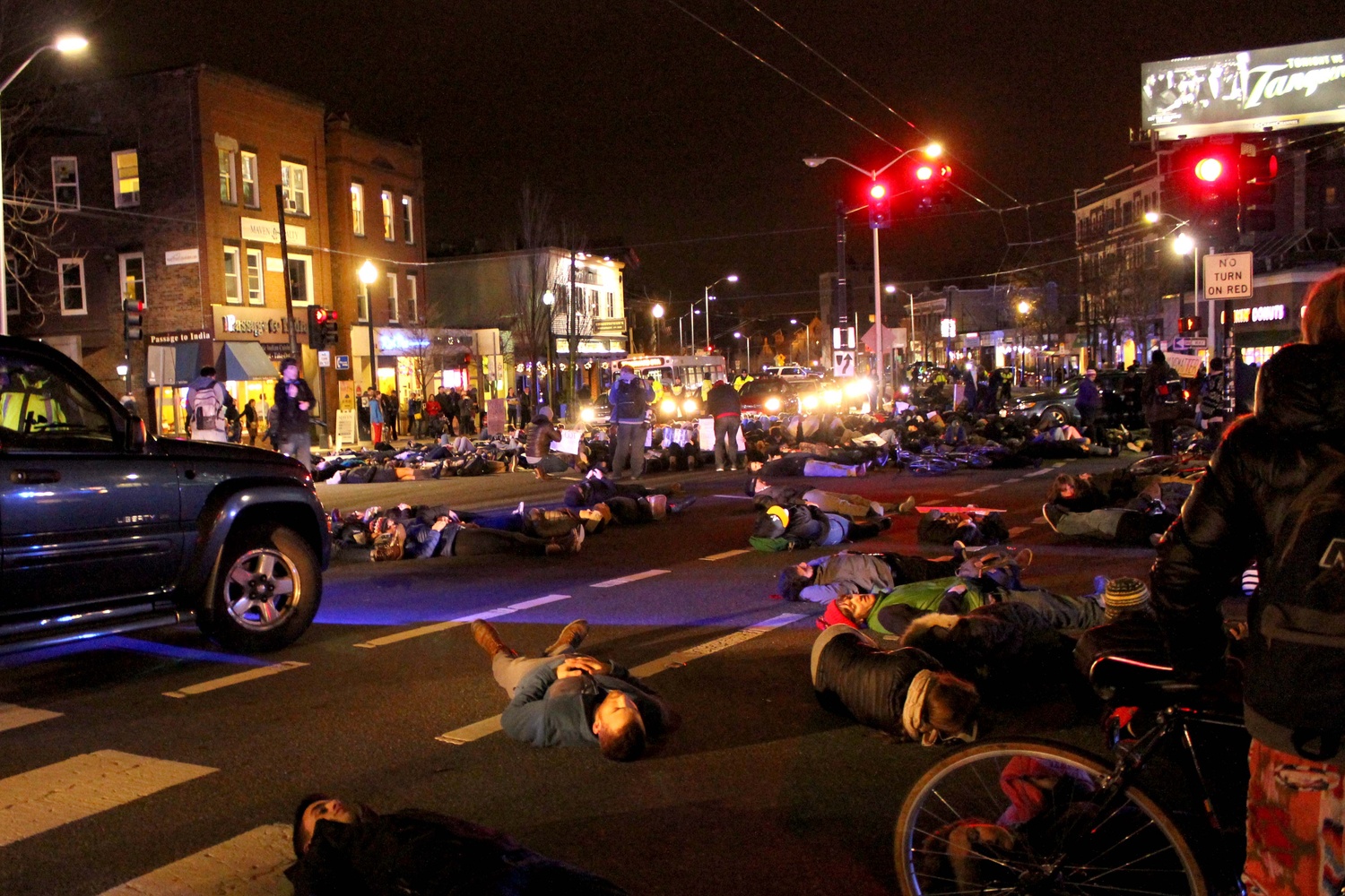 Protestors lay on Massachusetts Ave. during a "die-in" in Porter Square on Friday evening to protest the recent non-indictments of the officers in the Michael Brown and Eric Garner cases. Protestors began in Davis Square and continued to MIT, laying down at key transportation sites.