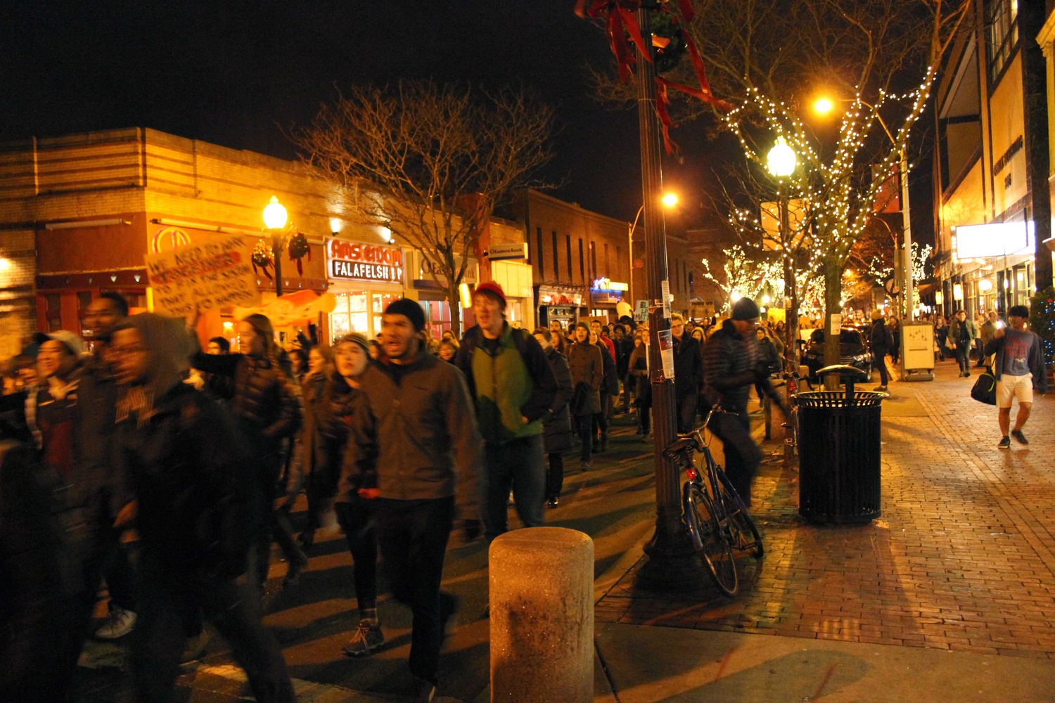 Protestors march from Davis Square to Porter Square on Friday evening in response to the recent non-indictments of the officers in the Michael Brown and Eric Garner cases. Protestors began in Davis Square and continued to MIT, laying down at key transportation sites.