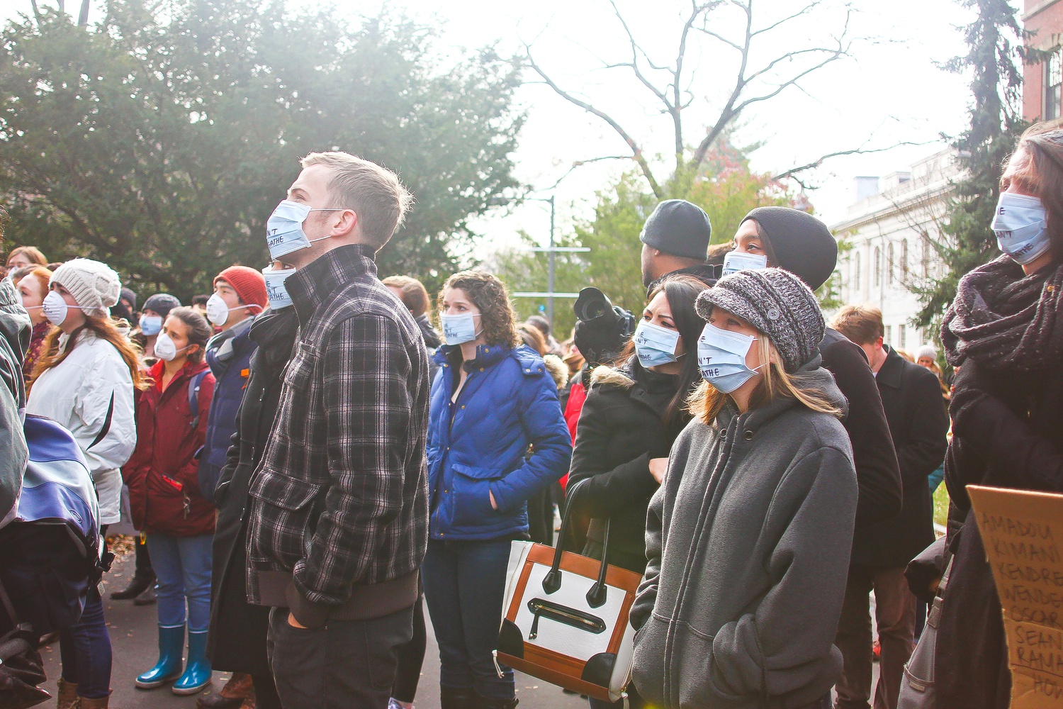 Members of both the Harvard community and community at large don oxygen masks at a die-in event at Memorial Church in December. The die-in was preceded by a sermon by Reverend Jonathan L. Walton, who helped organize the event.