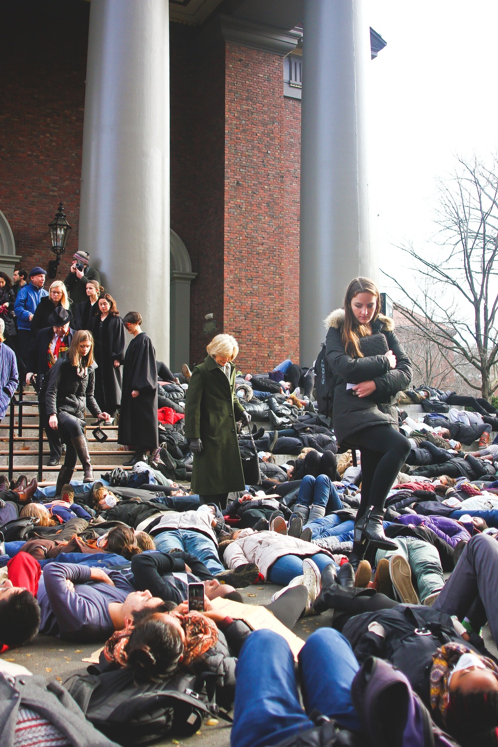 Service attendees step over bodies of protesters at the die-in event in December outside of Memorial Church.