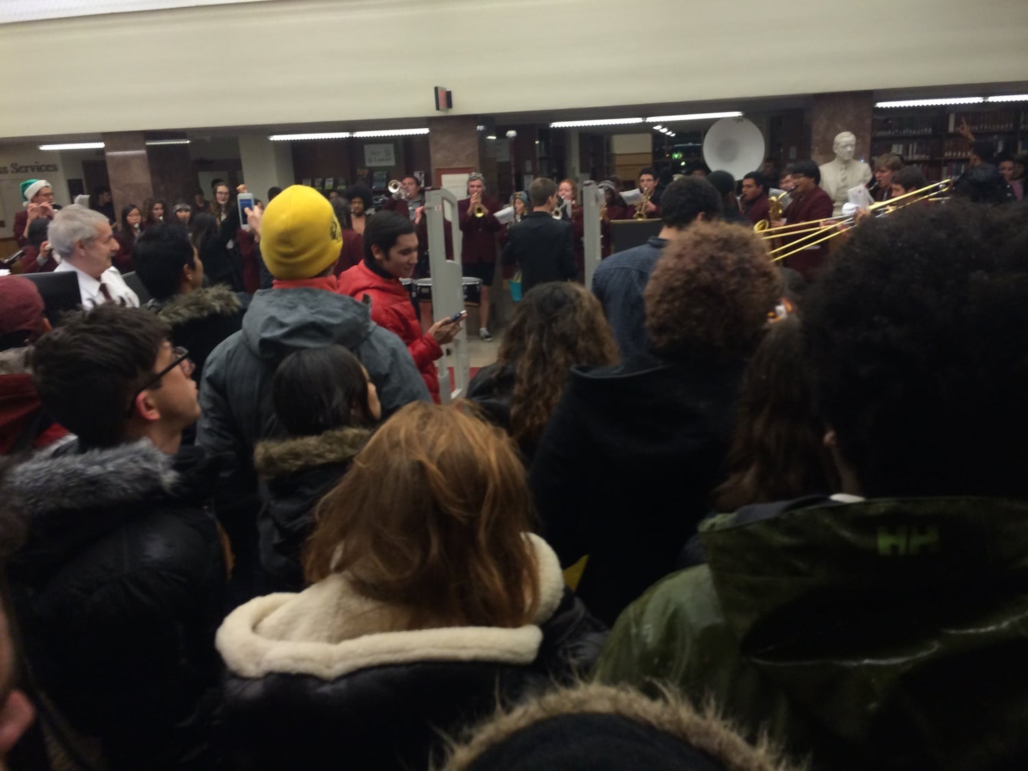 Protesters and members of the Harvard Band crowd the foyer of Lamont Library early Tuesday morning after the protesters tried to delay the start of Primal Scream with a moment of silence for victims of racial violence.