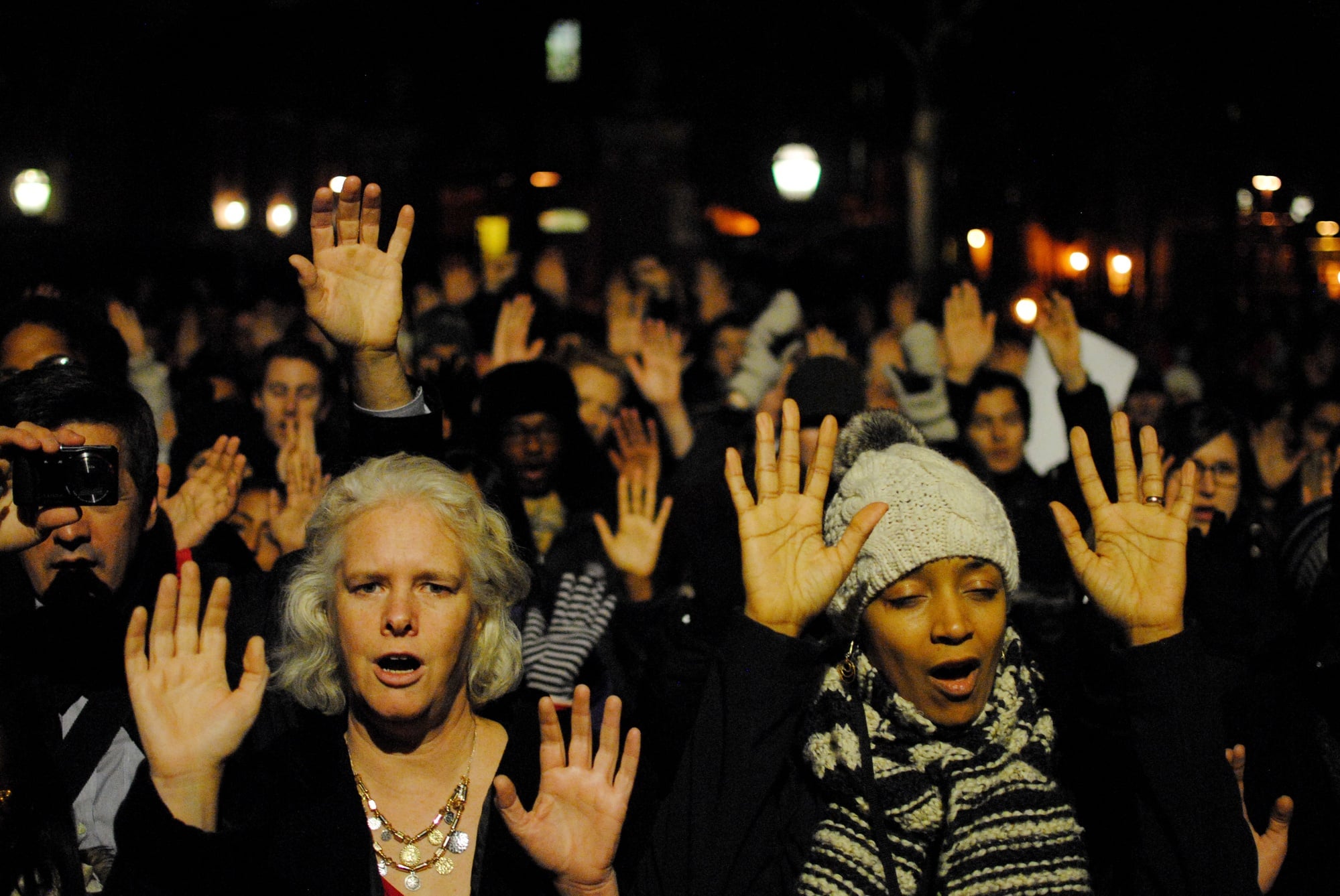 Members of the Harvard community chant "hands up don't shoot," at a peaceful protest in the Science Center Plaza in December. The protest brought together students from many Harvard University schools.