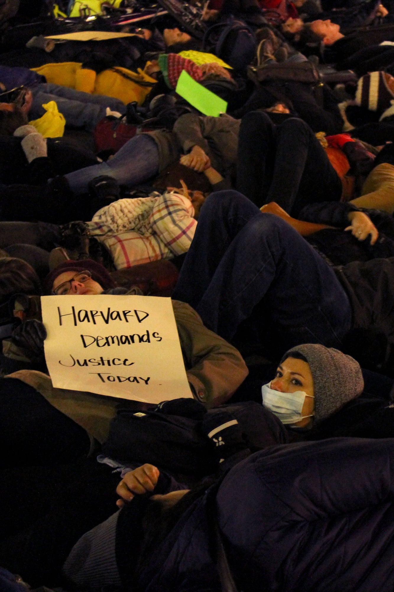 Protestors host a die-in in Cambridge on Friday evening to protest the two recent, separate Grand Jury decisions not to indict white police officers who killed unarmed black men.