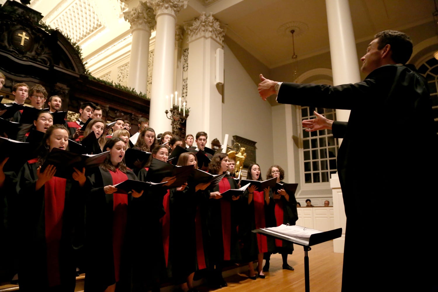 Memorial Church Choirmaster Edward E. Jones conducts the Harvard University Choir as it performs "Silent Night" on Monday evening in Memorial Church. The performance was part of the 105th Annual Christmas Carol Service.