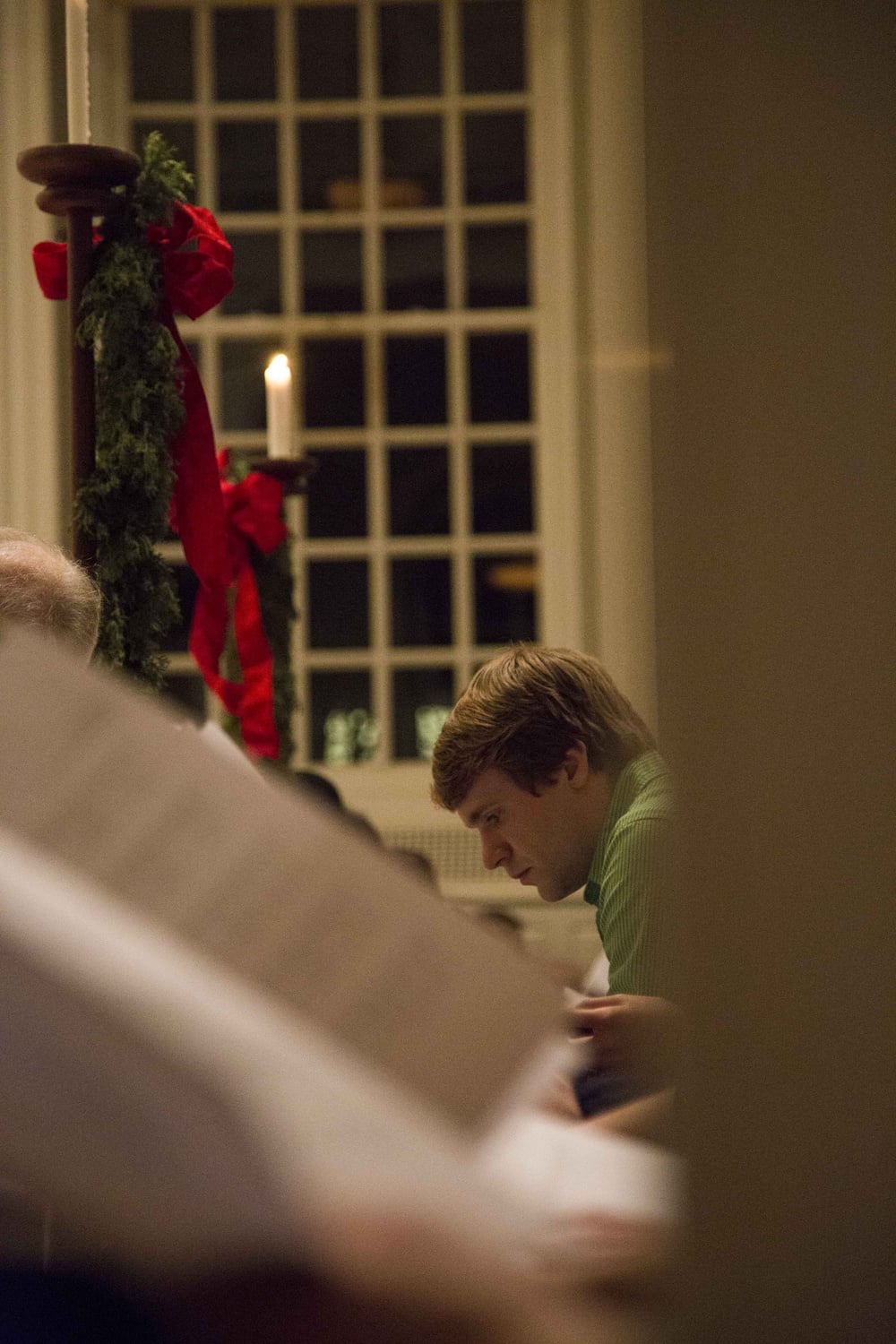 MJ Richardson '17 reads along during the 105th Annual Christmas Carol Service on Monday evening in Memorial Church. 