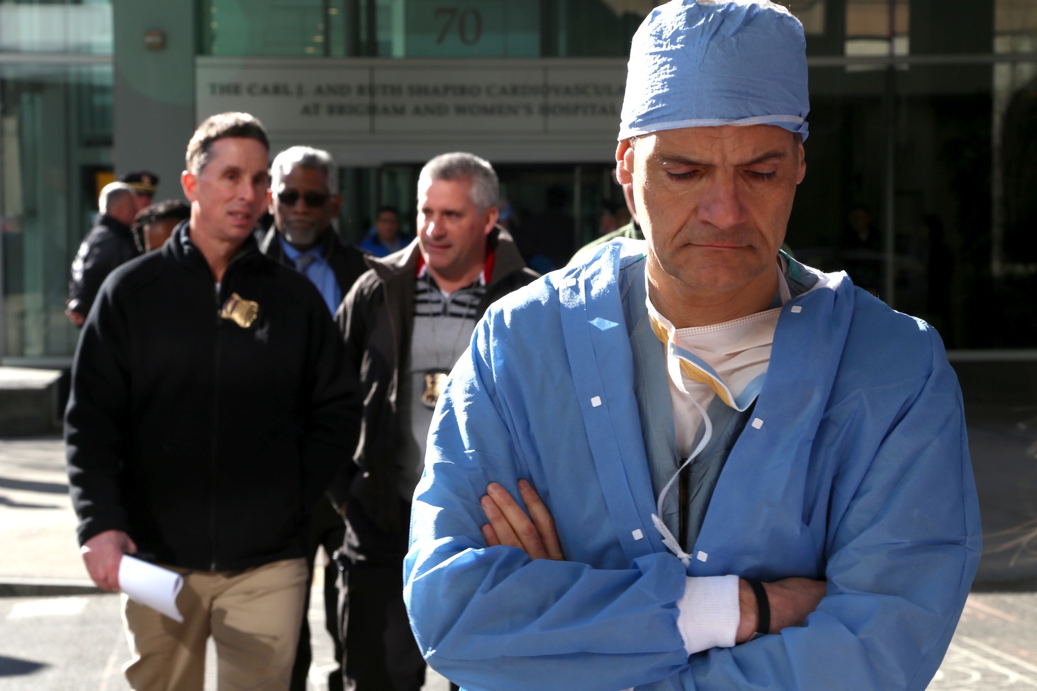 Members of the Boston Police Department and Brigham and Women's Hospital personnel cross Francis Street away from the Harvard-affiliated hospital's Shapiro building, where Harvard Medical School Assistant Professor Michael J. Davidson was shot on Tuesday morning.
