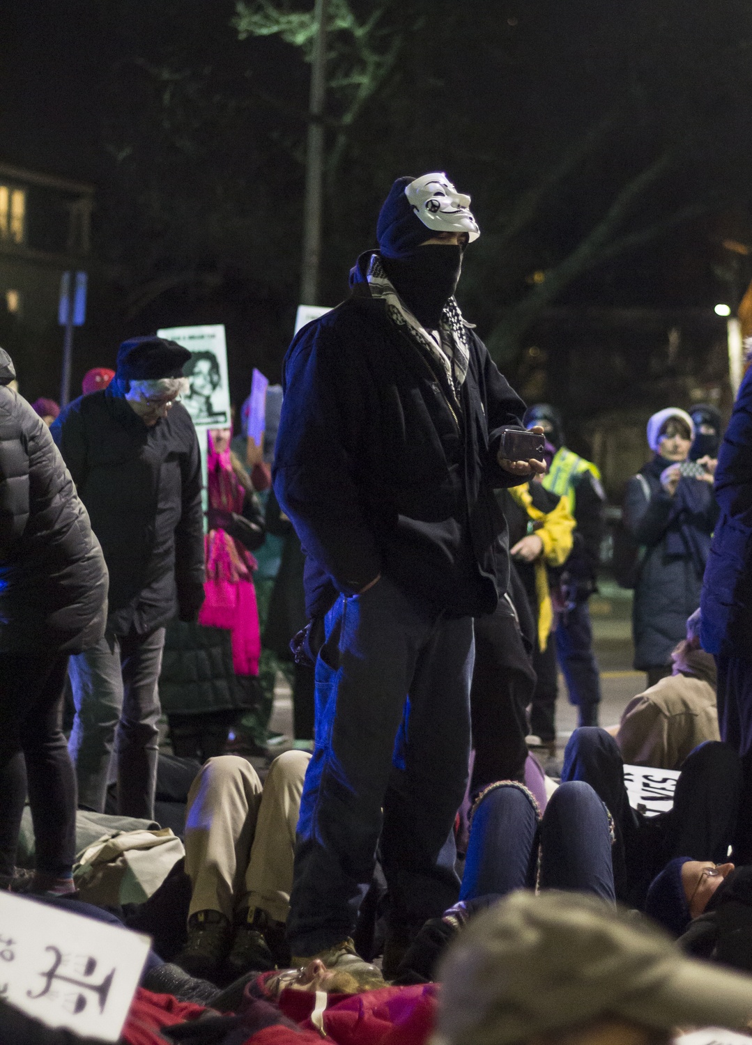 A protester takes photos of the "die-in" at the "Black Lives Matter" protest in Cambridge on Wednesday evening.