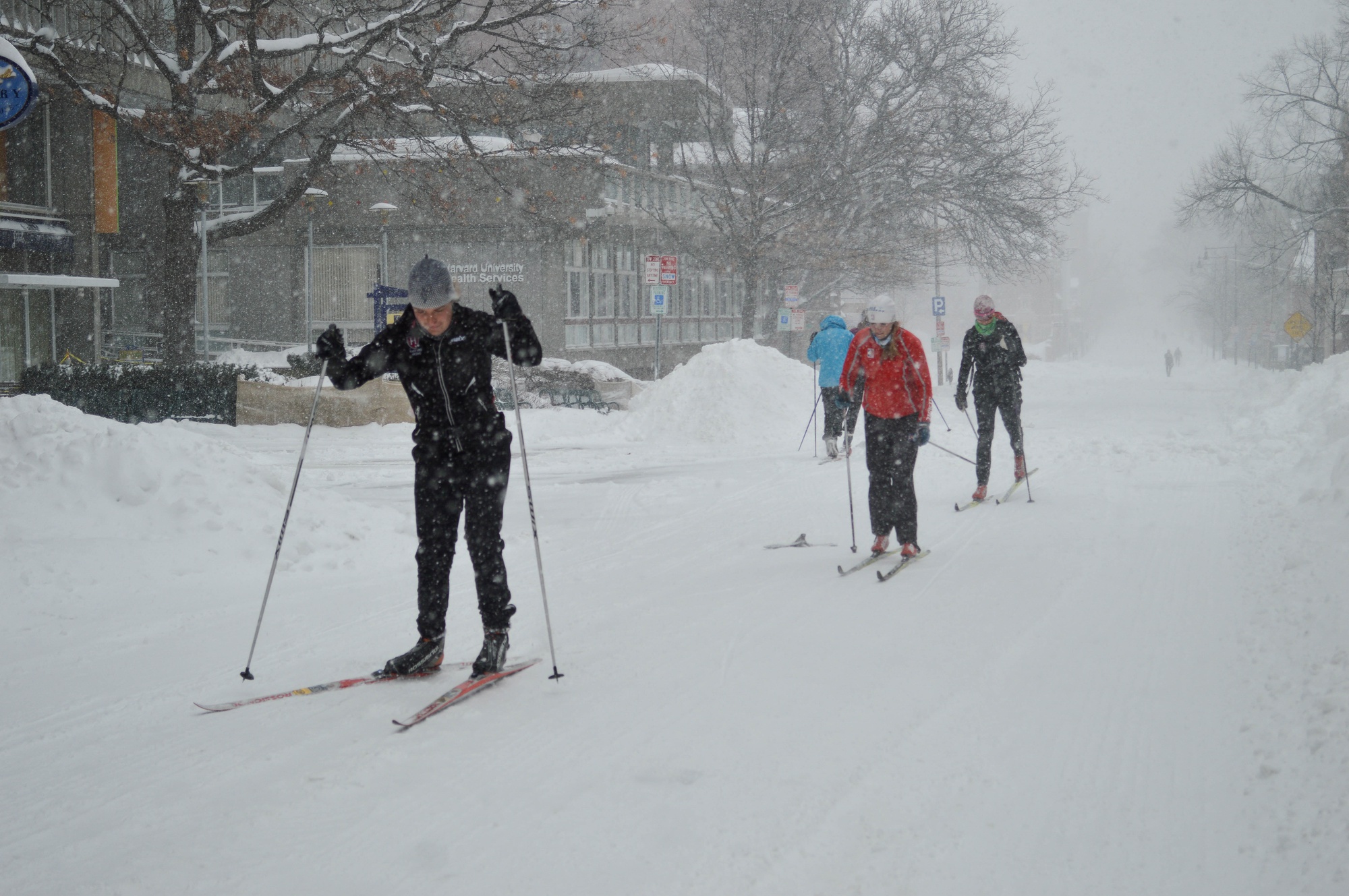 People skied down mostly empty streets in Cambridge Tuesday as snow blanketed the area.