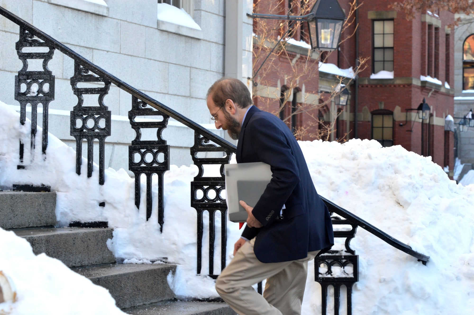 Provost Alan M. Garber ’76 enters University Hall to attend the semester’s first meeting of the Faculty of Arts and Sciences. The body voted to add a new Ph.D. program and learned that two students were dismissed for sexual misconduct in December.
